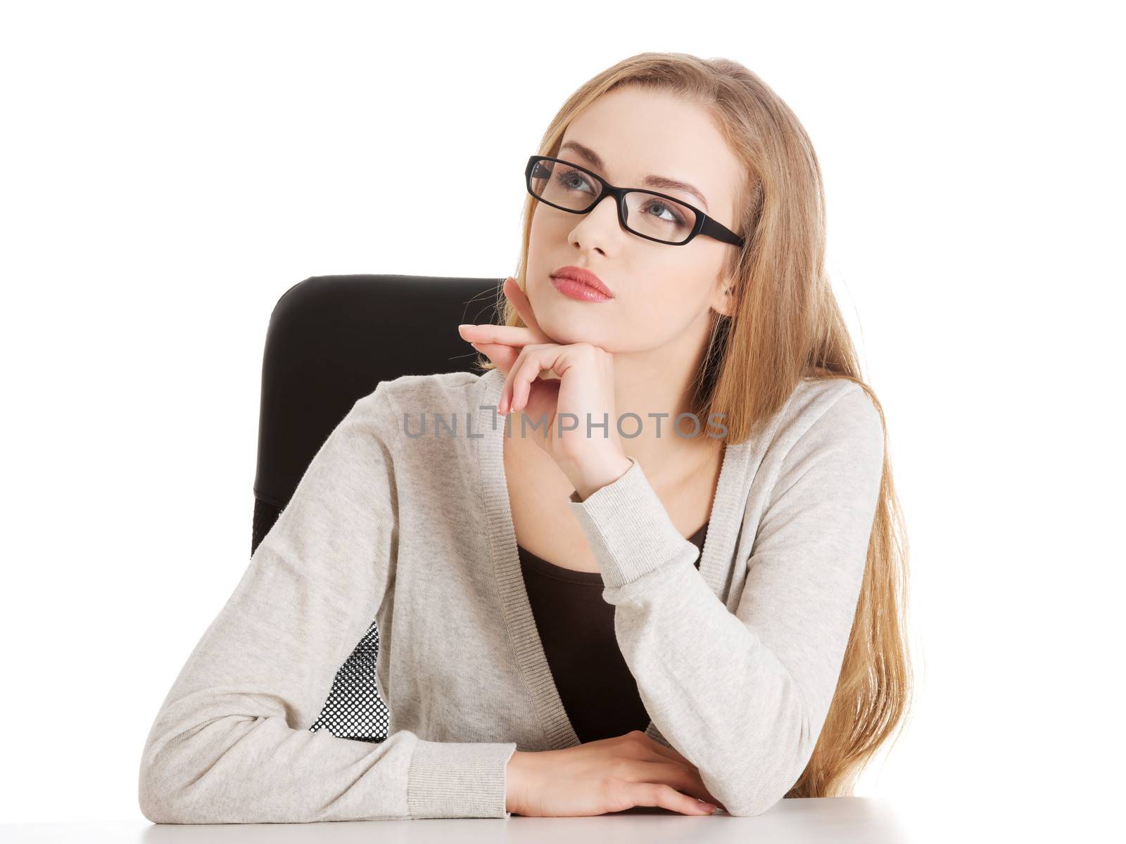 Portrait of beautiful thoughtful woman in eyeglasses sitting. Isolated on white.