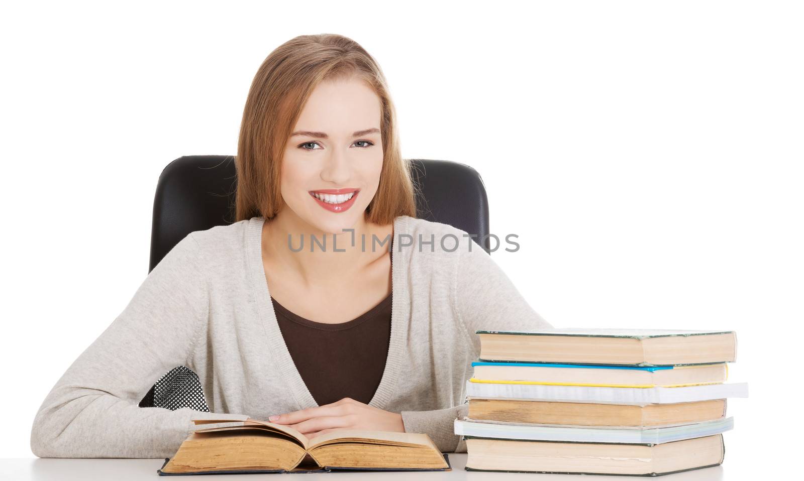 Beautiful student woman sitting by the desk with books and learn by BDS