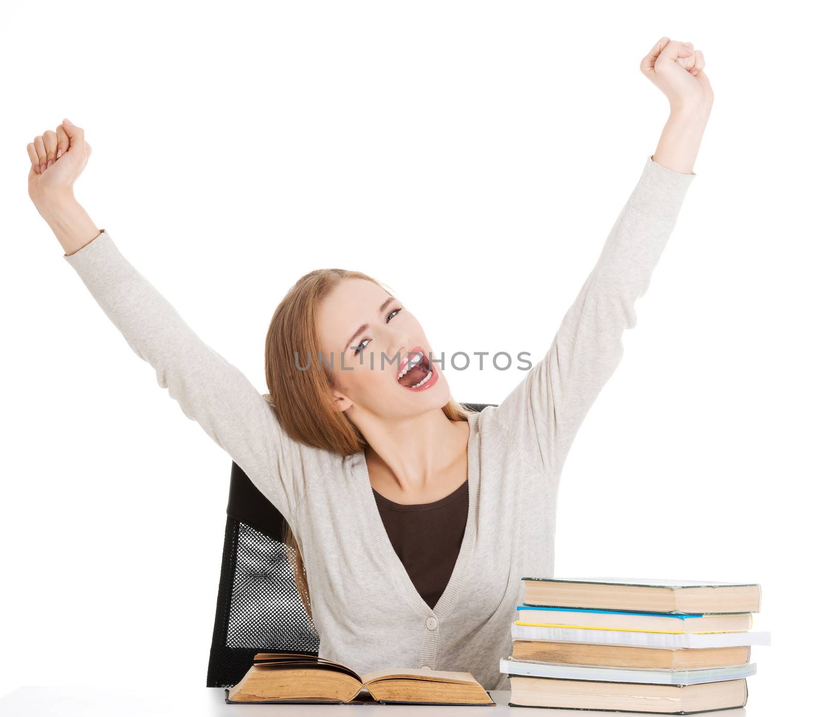 Happy student woman with her hands up and stack of books. by BDS