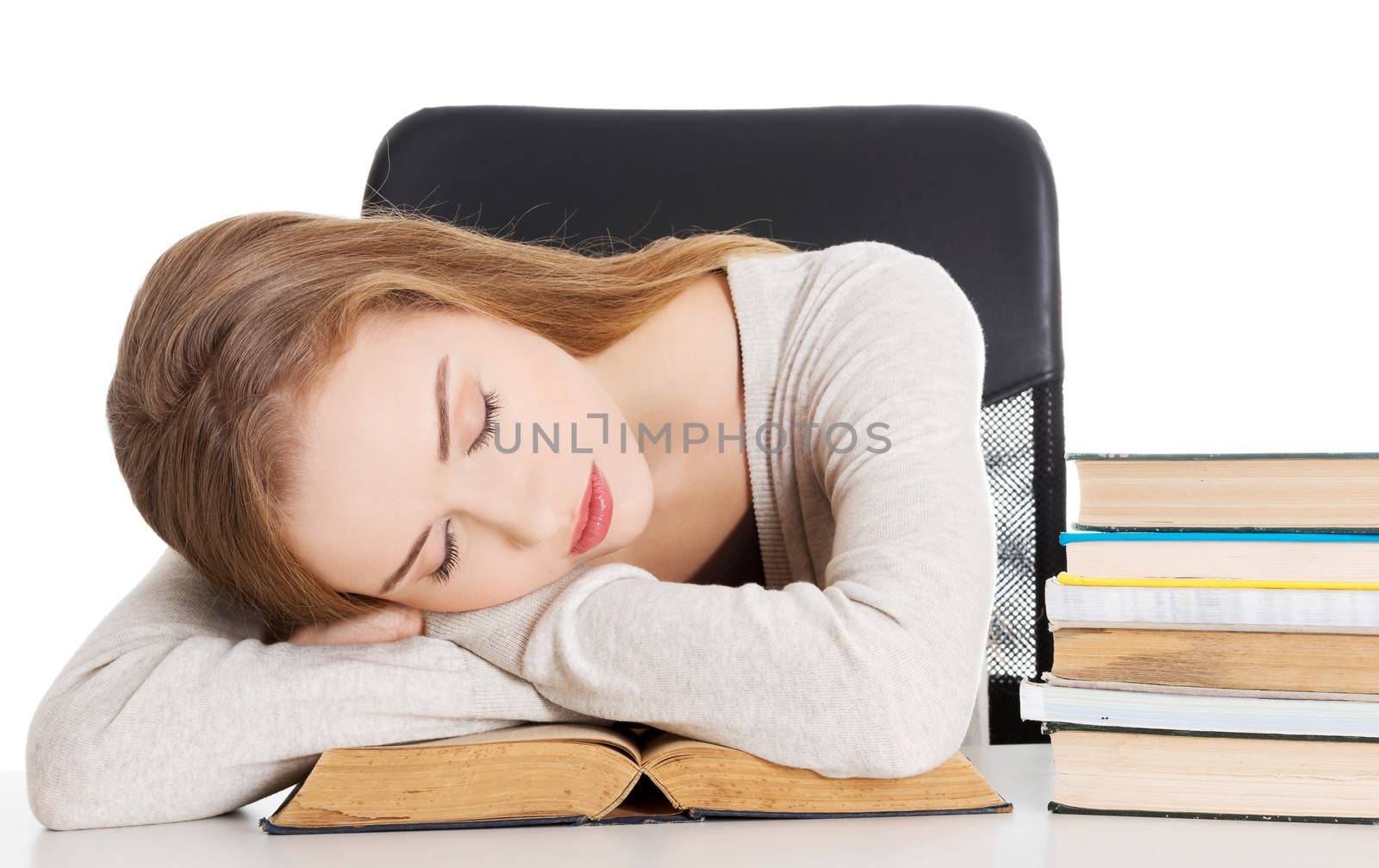 Beautiful woman is sleeping on a book. Student and education concept. Isolated on white.