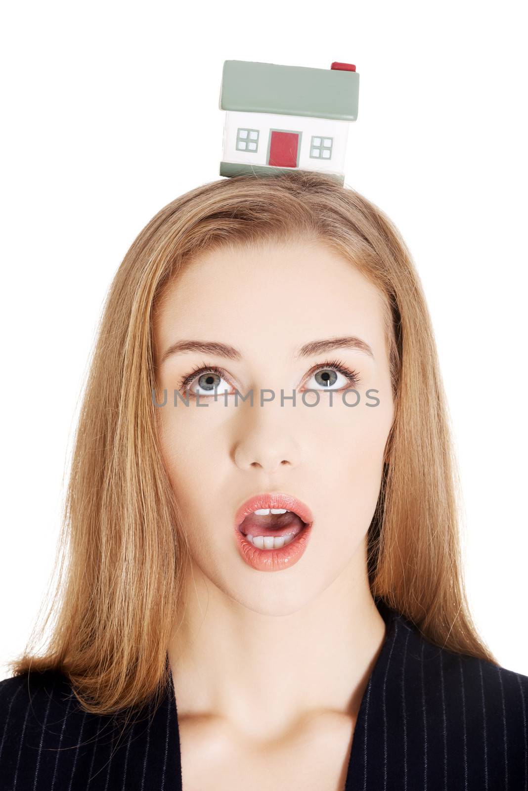Portrait of beautiful business shocked woman with house on head. by BDS