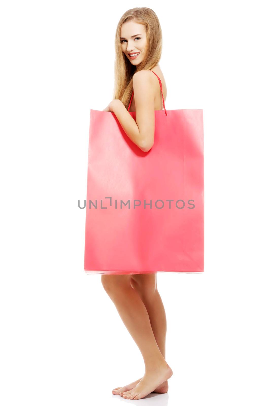Beautiful naked woman with big red shopping bag. Isolated on white.