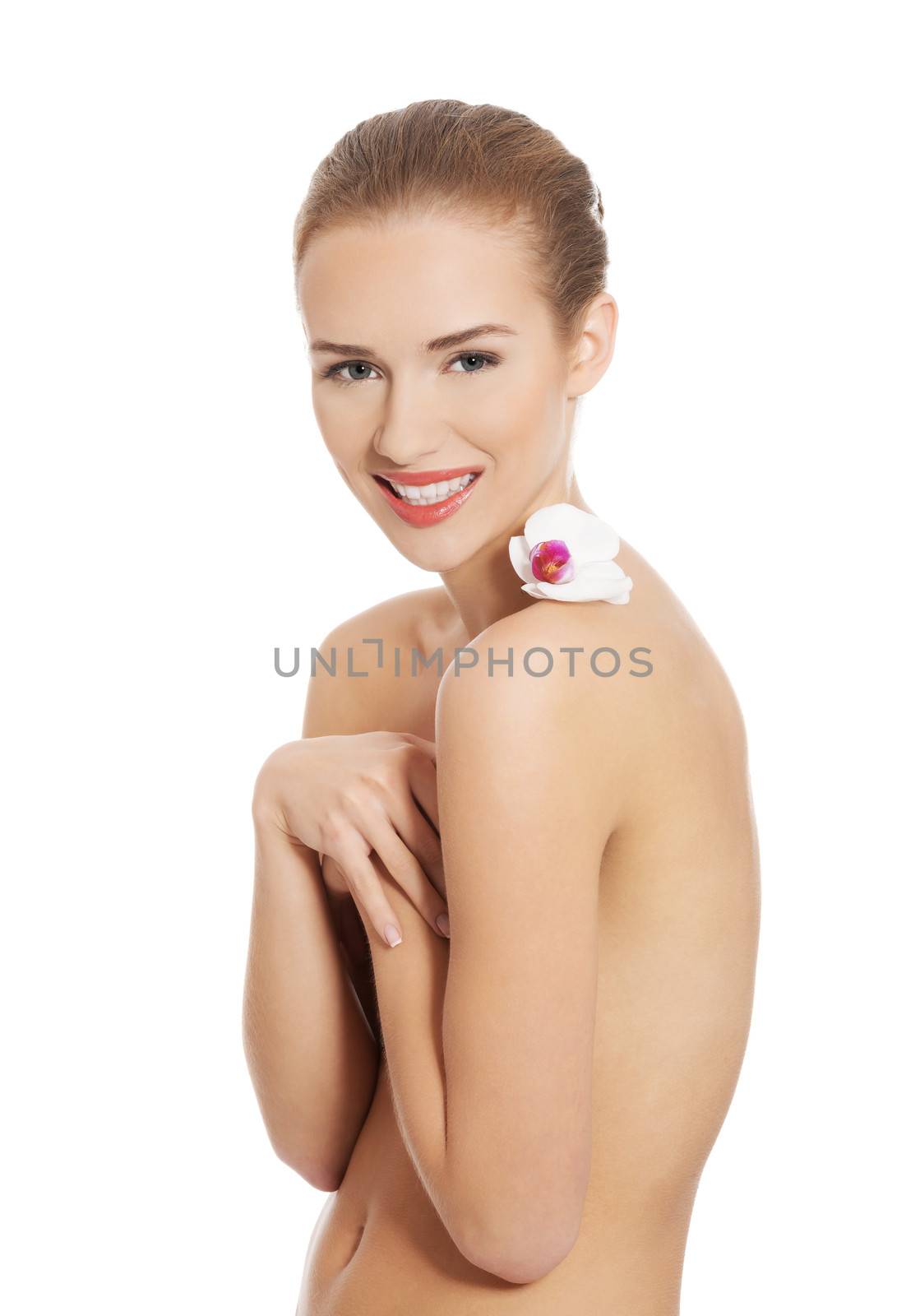 Nude naked woman having white flower on shoulders. Isolated on white.