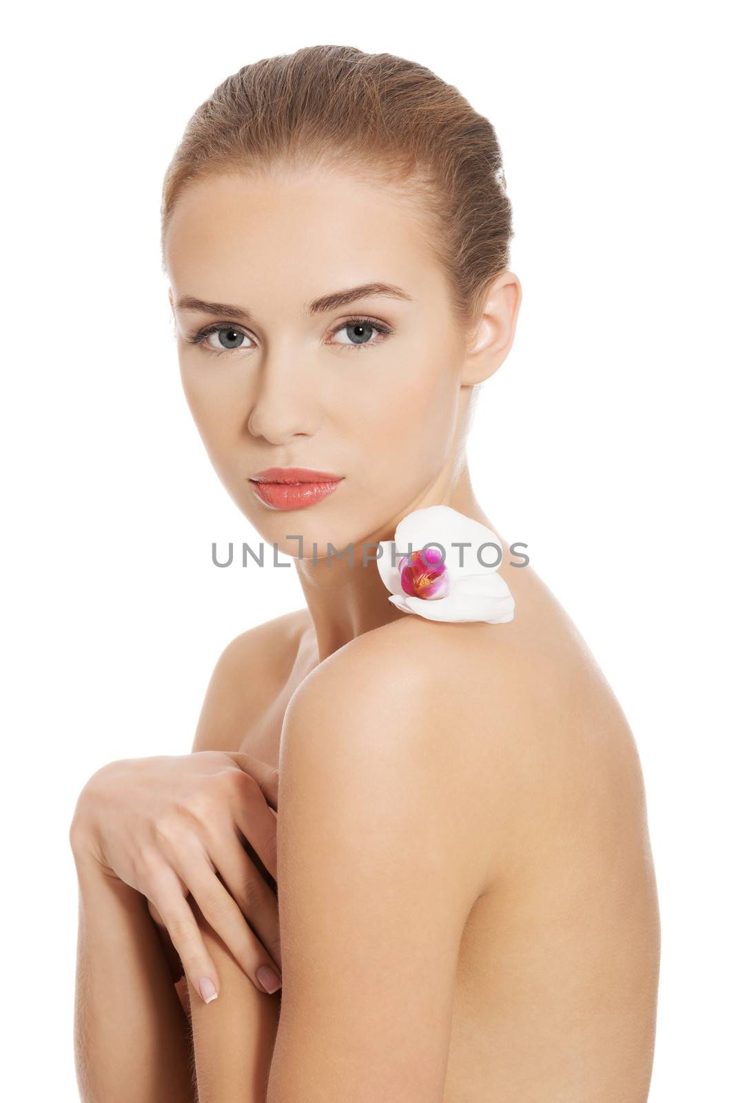 Nude naked woman having white flower on shoulders. Isolated on white.