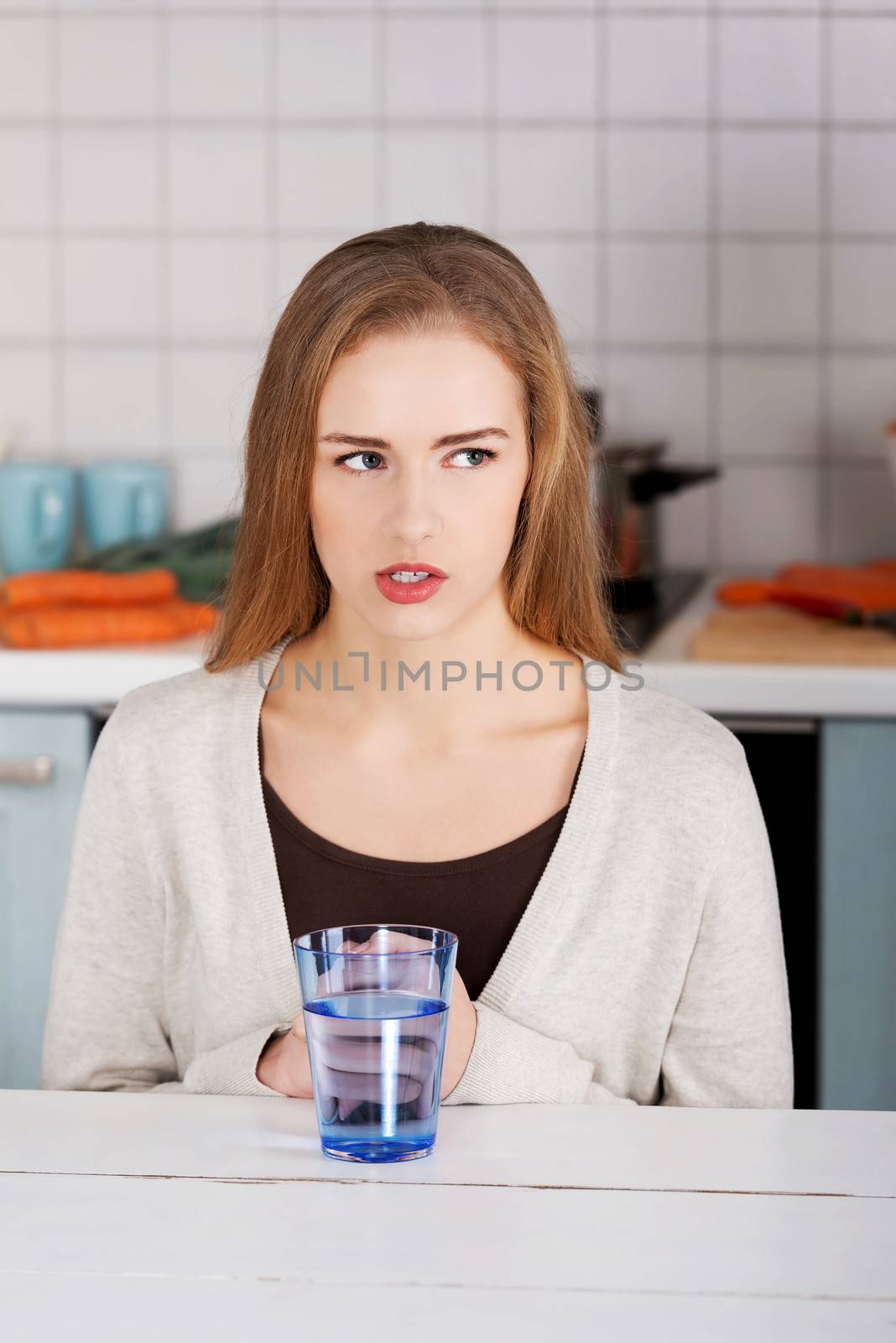 Beautiful caucasian woman sitting in the kitchen by BDS