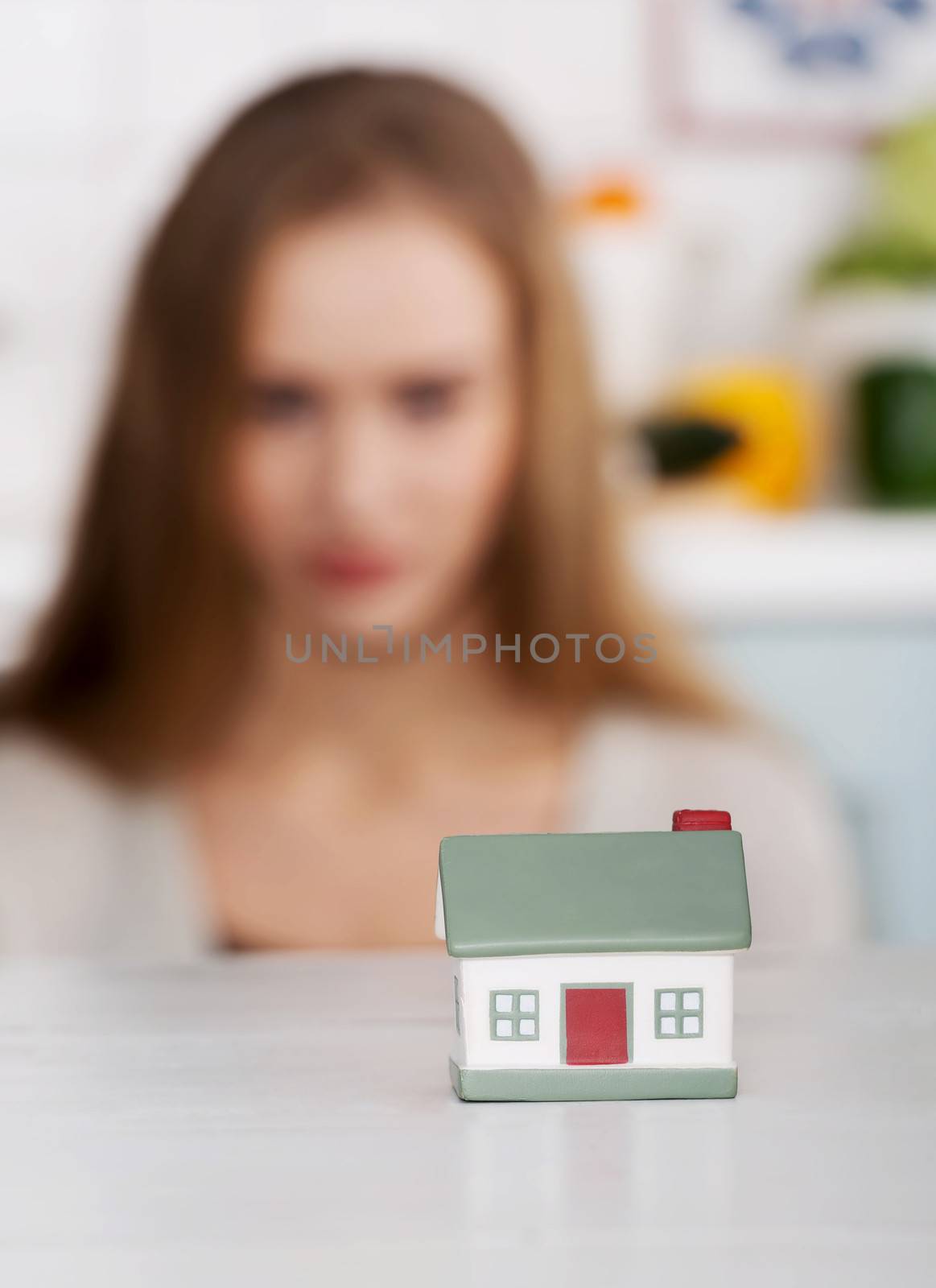 Beautiful caucasian woman and small house model. by BDS