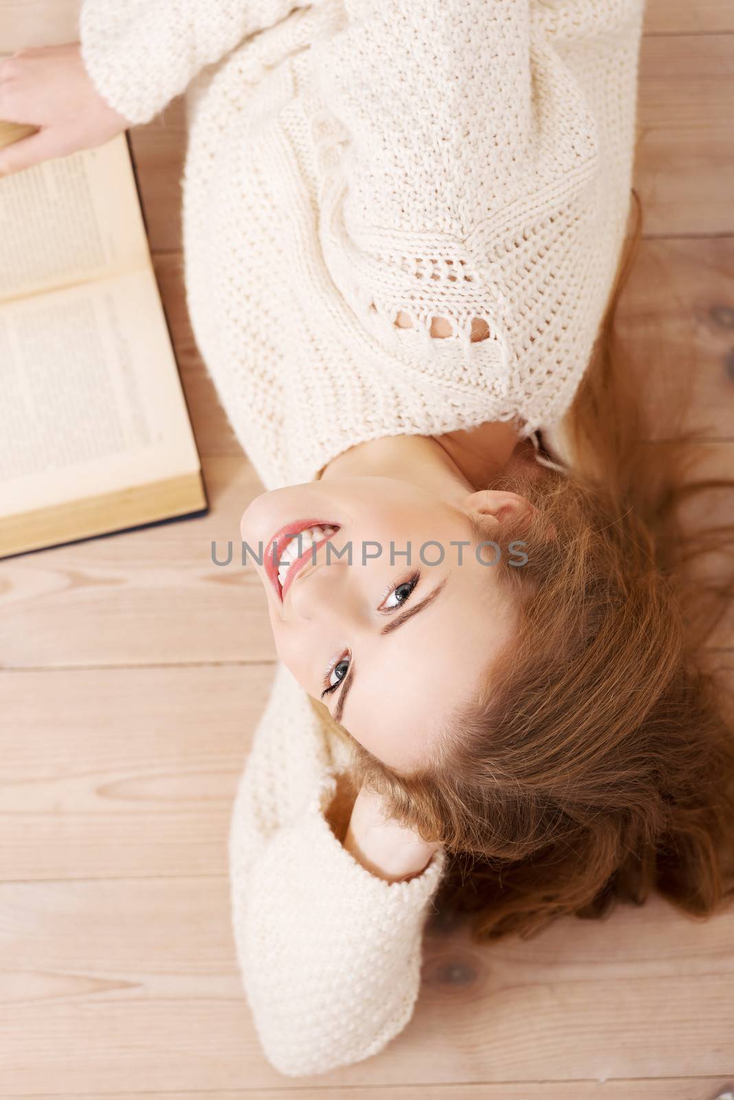 Relaxed young student woman lying on the floor by BDS