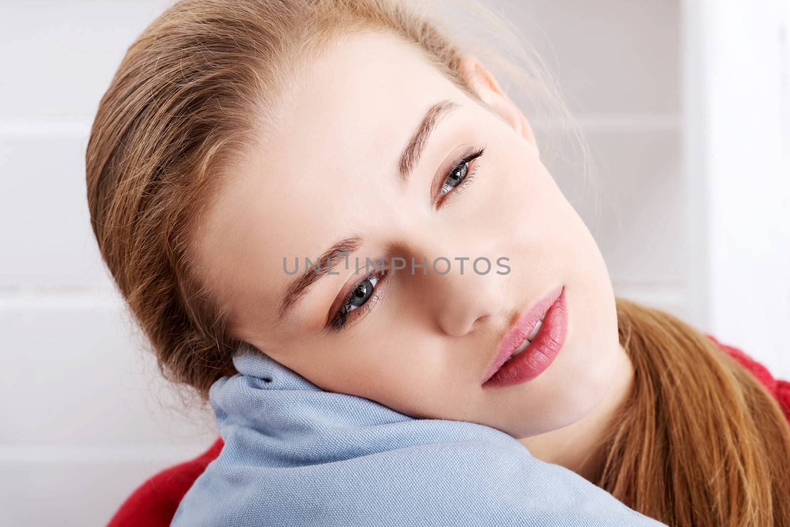 Portrait of beautiful caucasian bare woman with pillow. Head and shoulders.