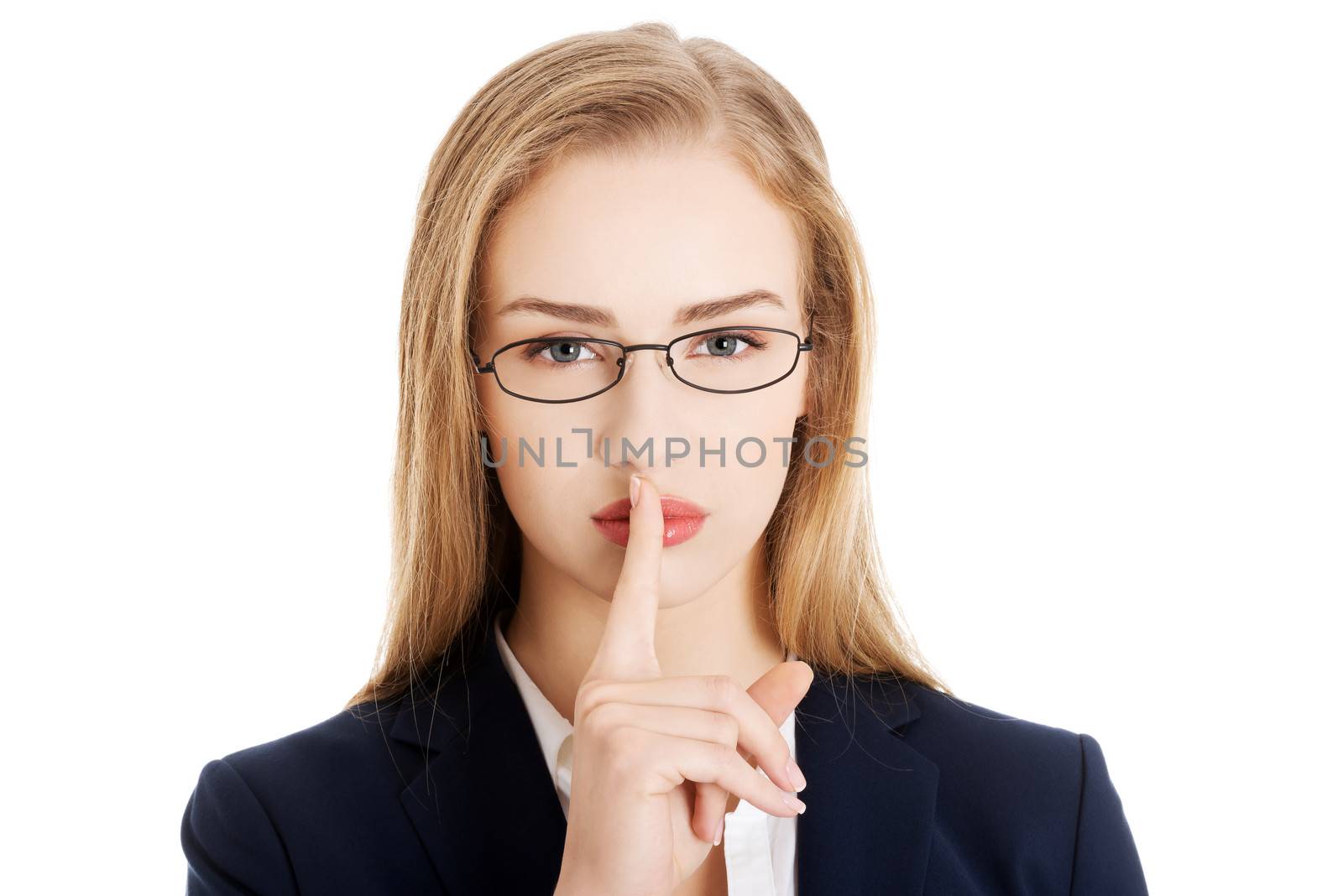 Beautiful business woman with finger on lips. by BDS