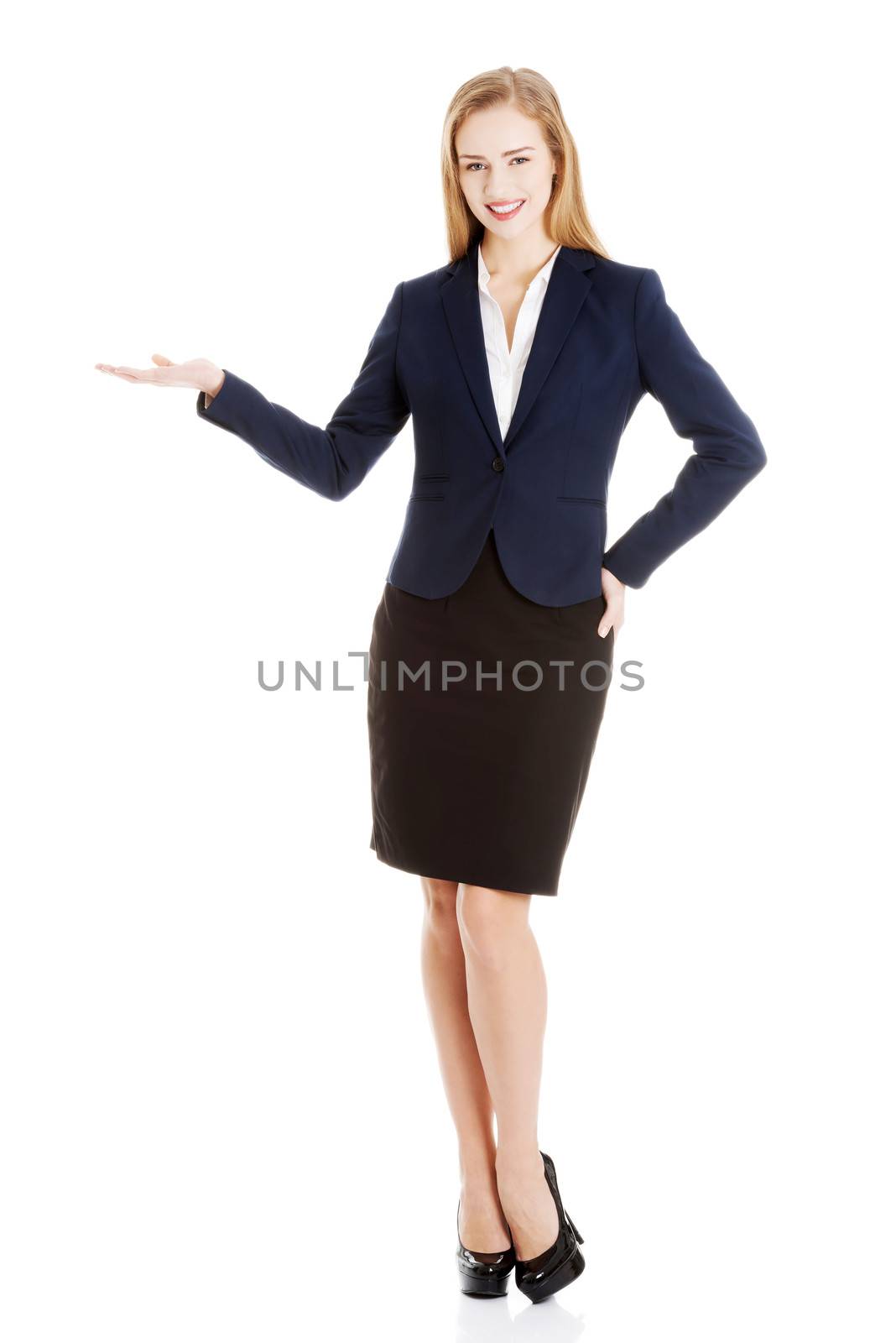 Business woman showing empty space on her palm and advertising. Isolated on white.