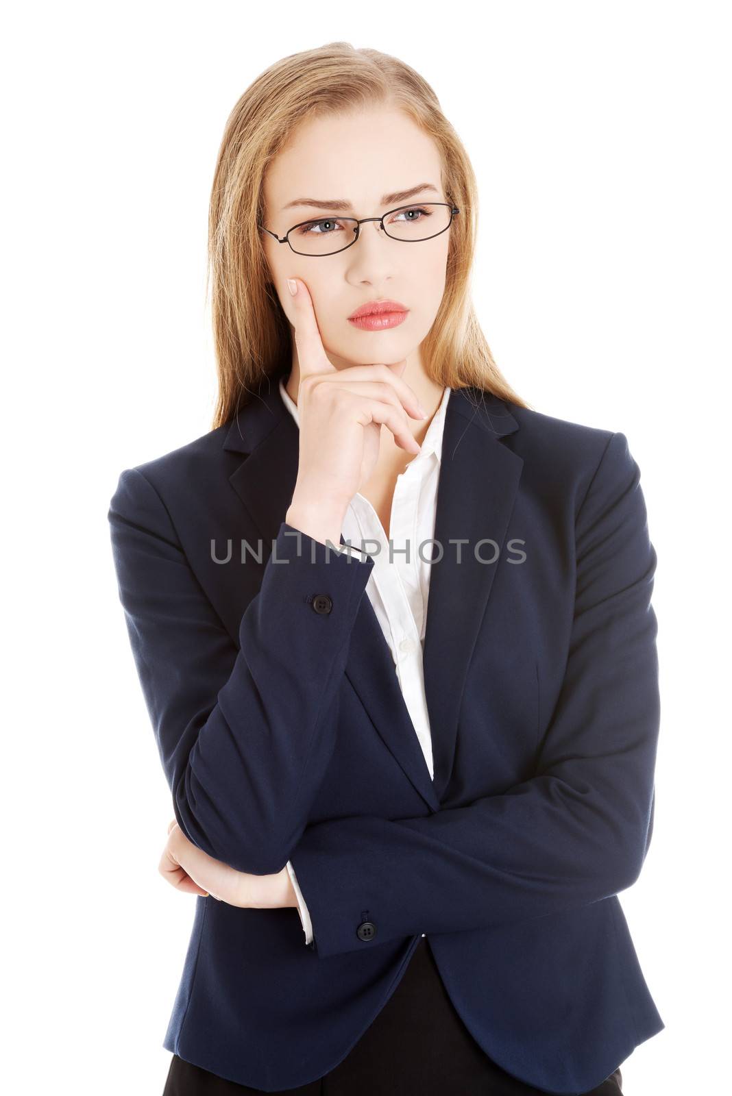 Beautiful business woman with her finger on cheek thinking. Isolated on white.