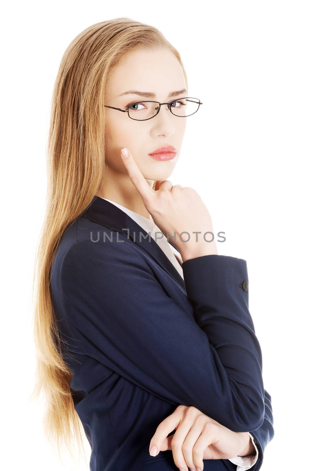 Beautiful business woman with her finger on cheek thinking. Isolated on white.