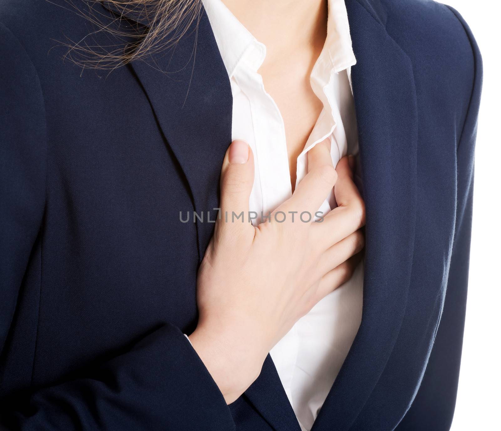 Beautiful business woman touching her chest, feeling unwell. Heart attach, health concept. Isolated on white.