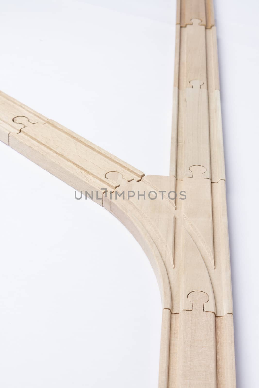 forked wooden railroad track on grey background. vertical image