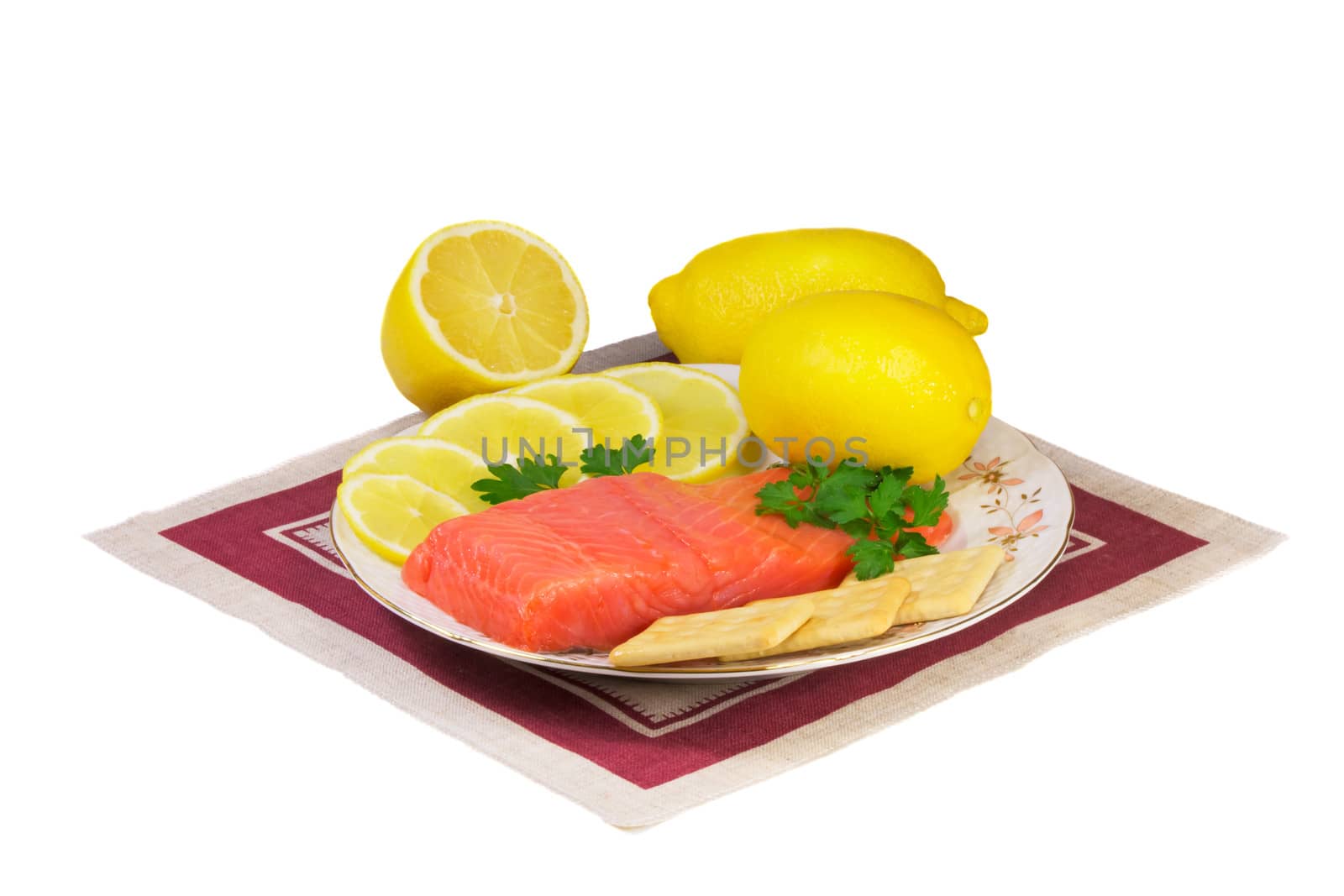 Salmon fillet and lemons on a platter on a white background. by georgina198