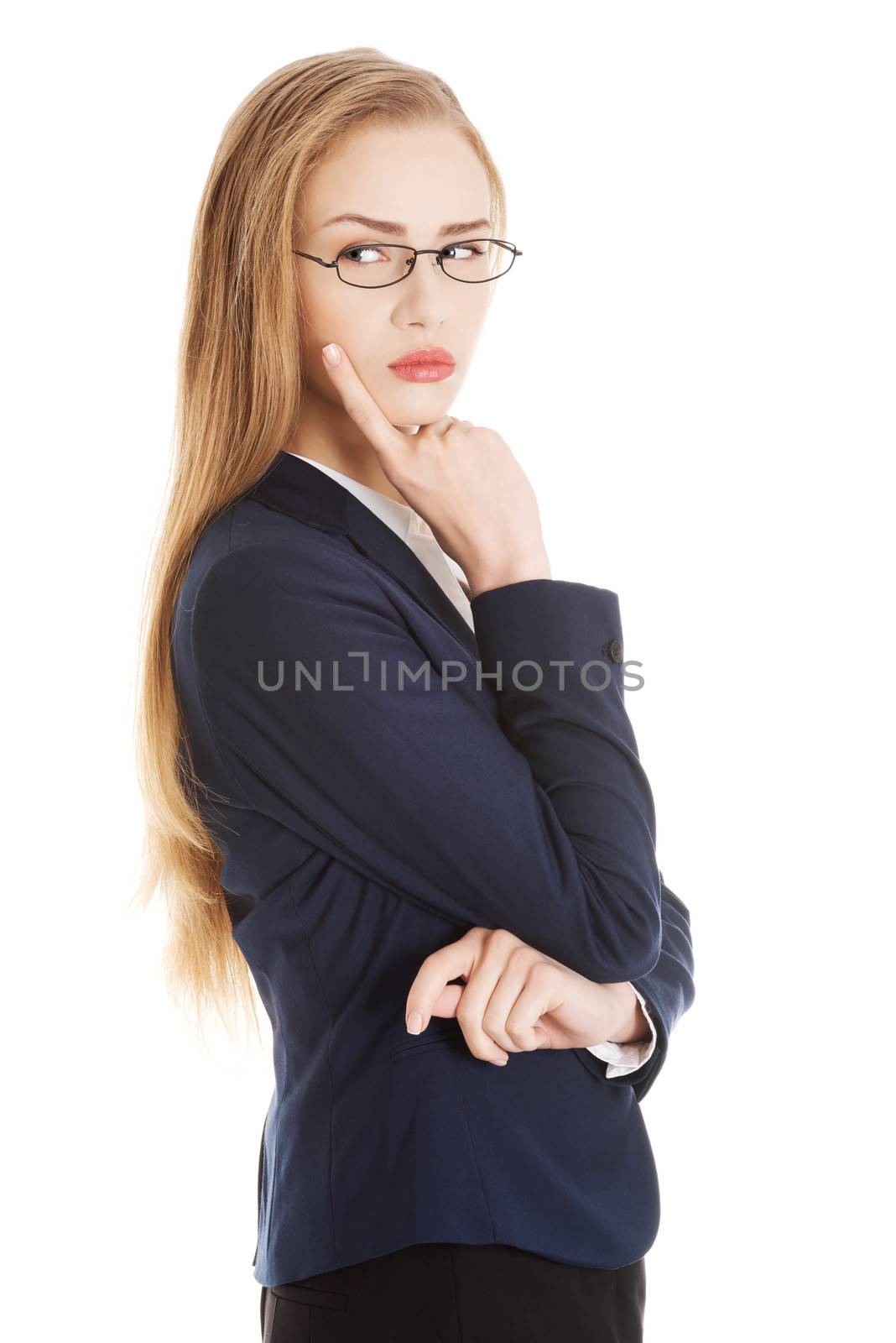 Beautiful business woman in eyeglasses with finger on her cheek. by BDS