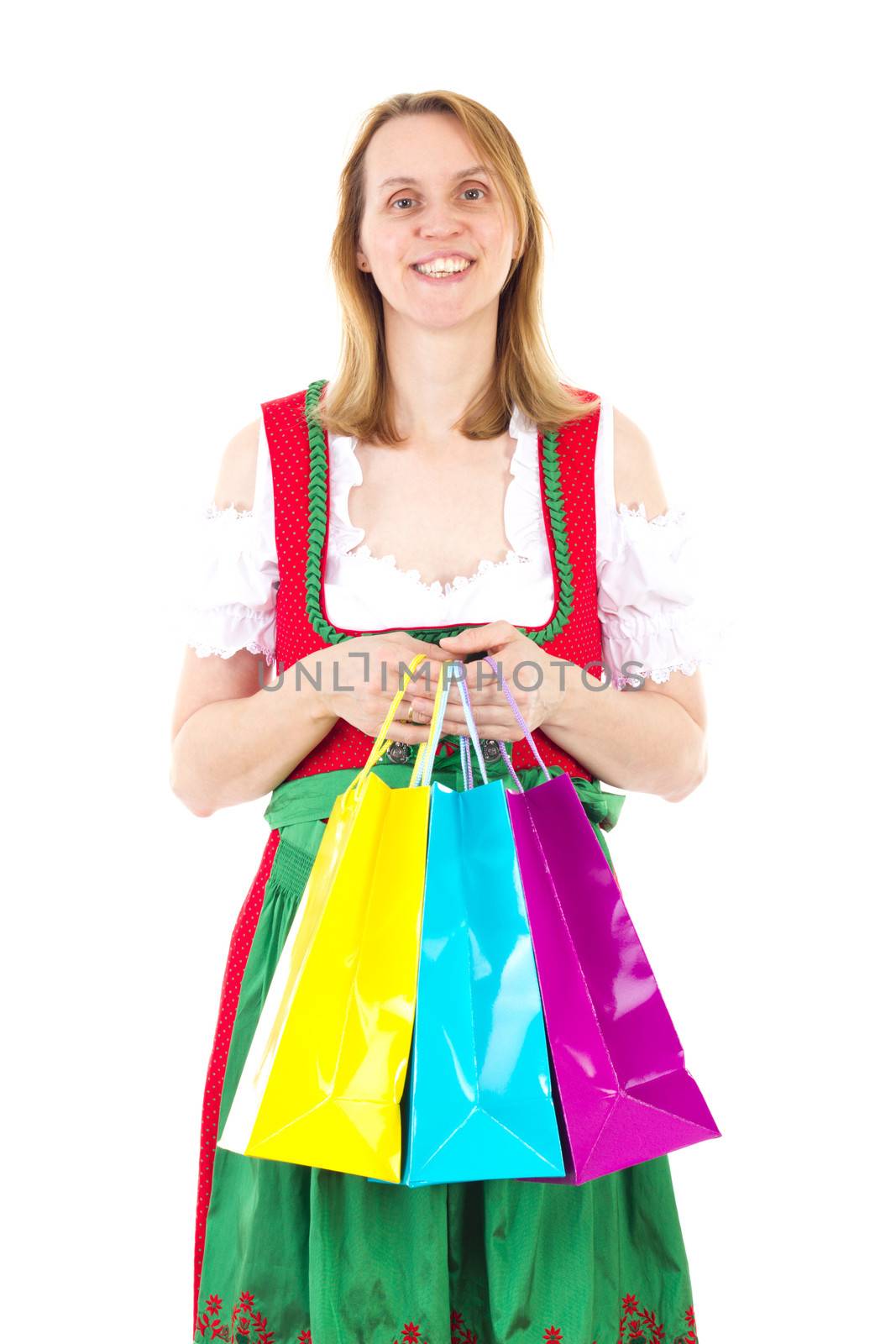 Smiling woman in red dirndl is happy about new clothes