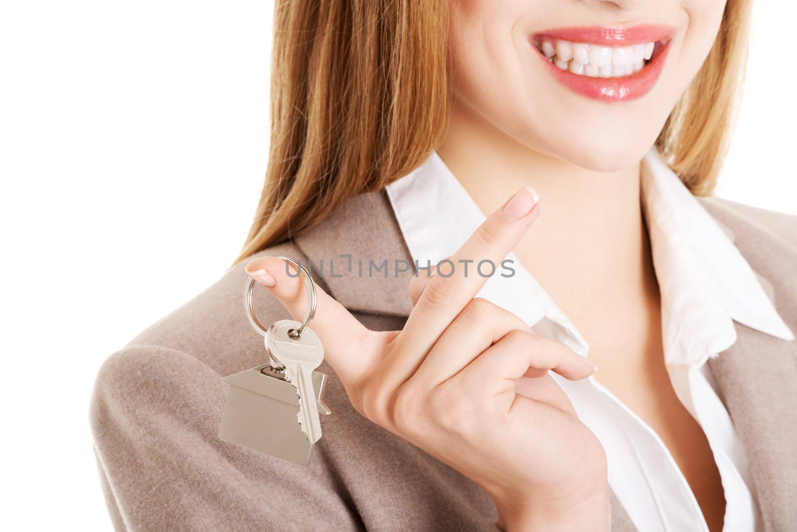 Young business caucasian woman is holding house keys. Over white background.