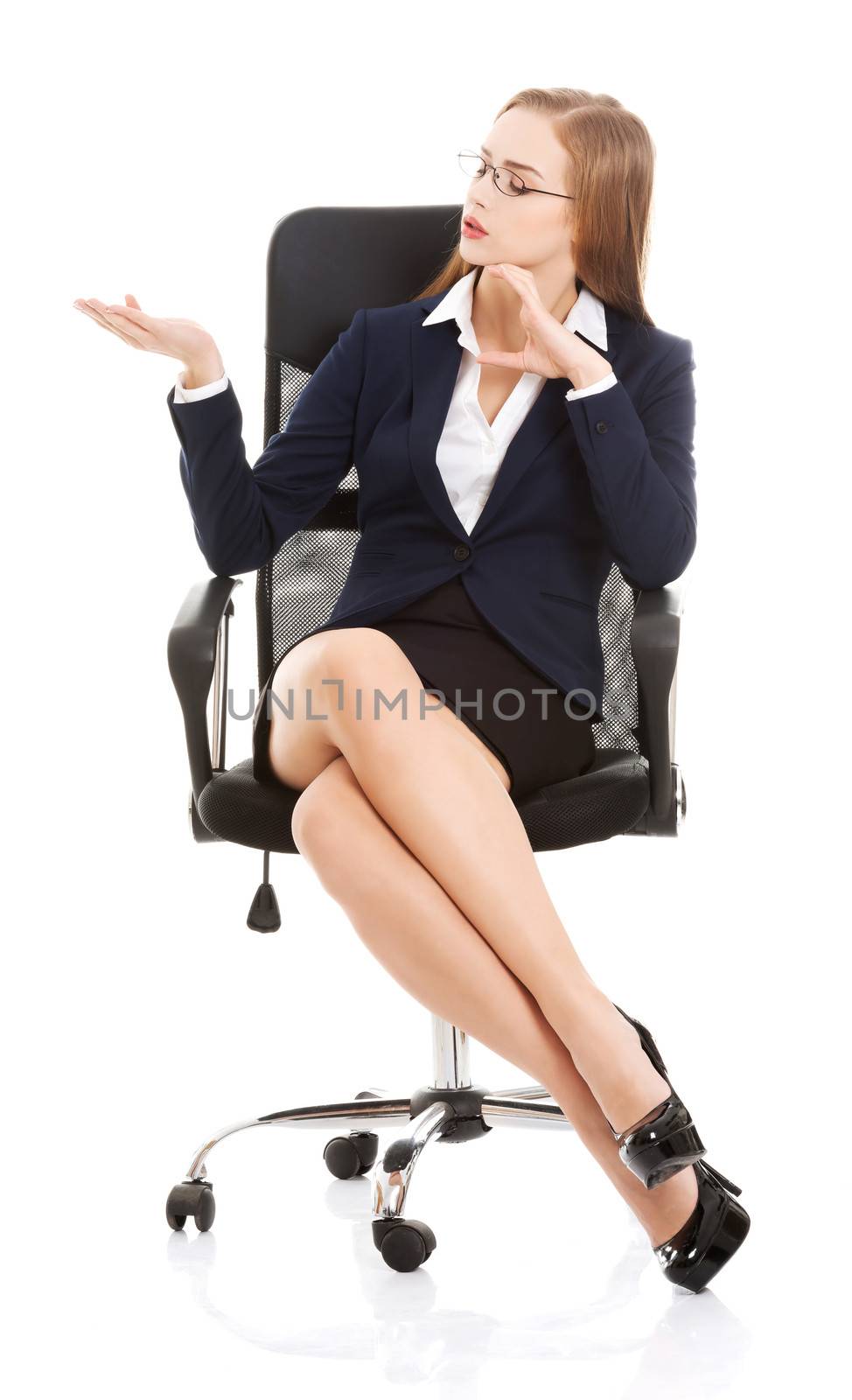 Beautiful caucasian business woman sitting on a chair and advertising. Isolated on white.