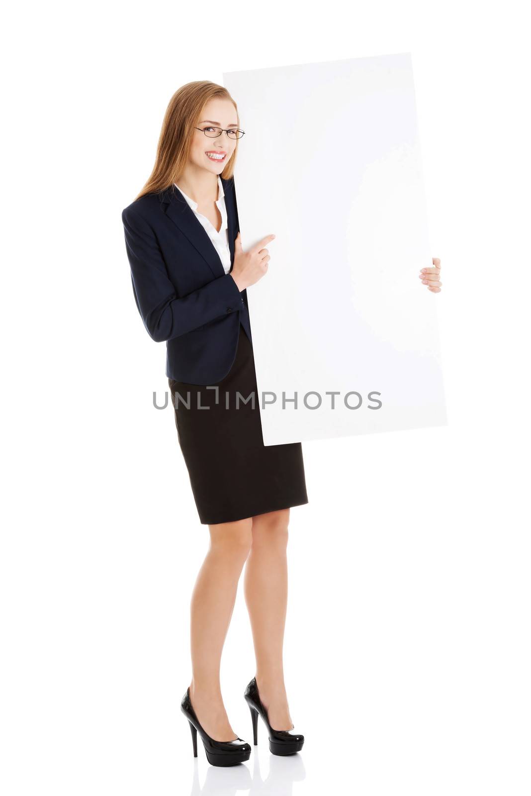 Beautiful young business woman holding copy space. Isolated on white.