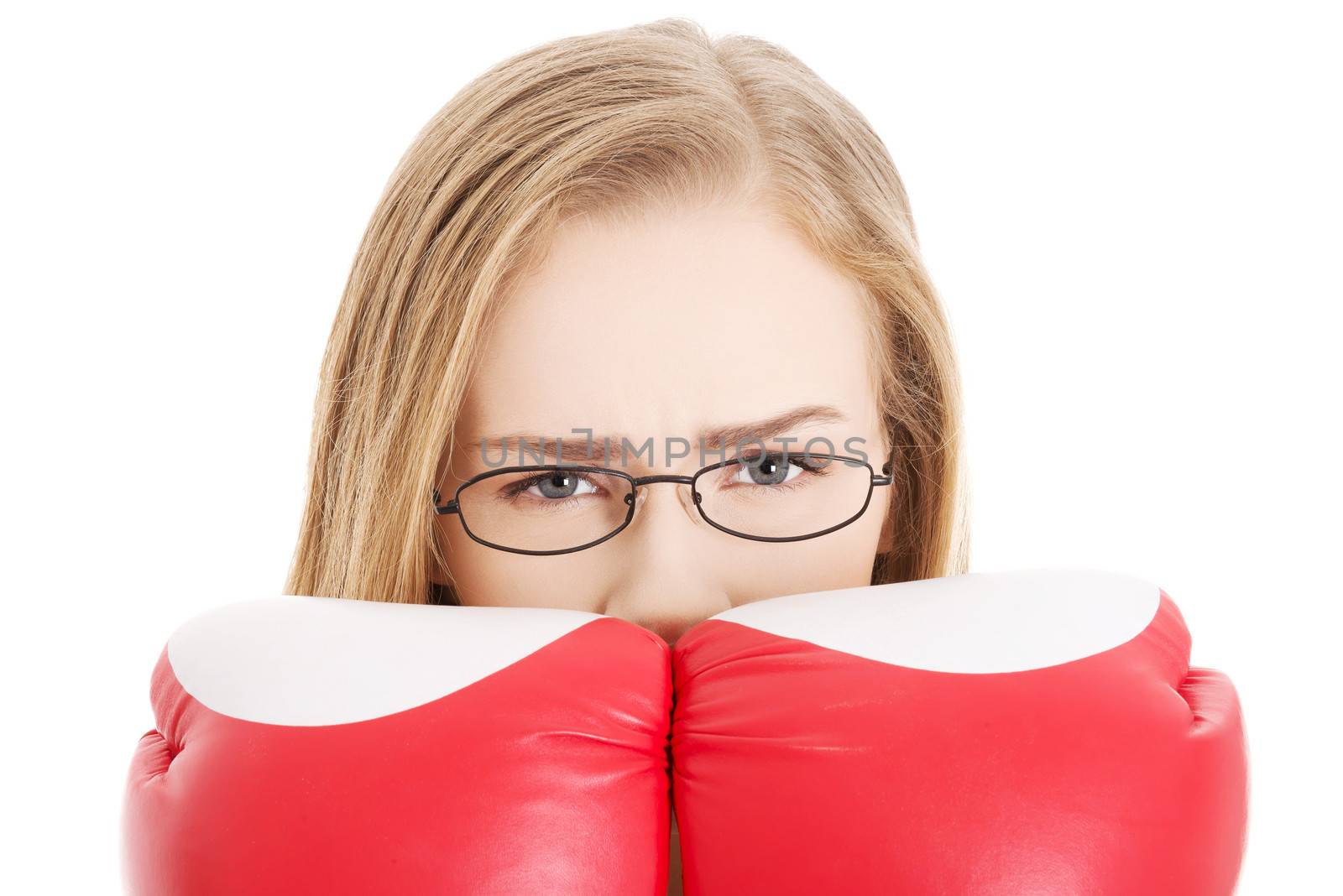 Beautiful caucasian woman behind boxing gloves. Isolated on white.