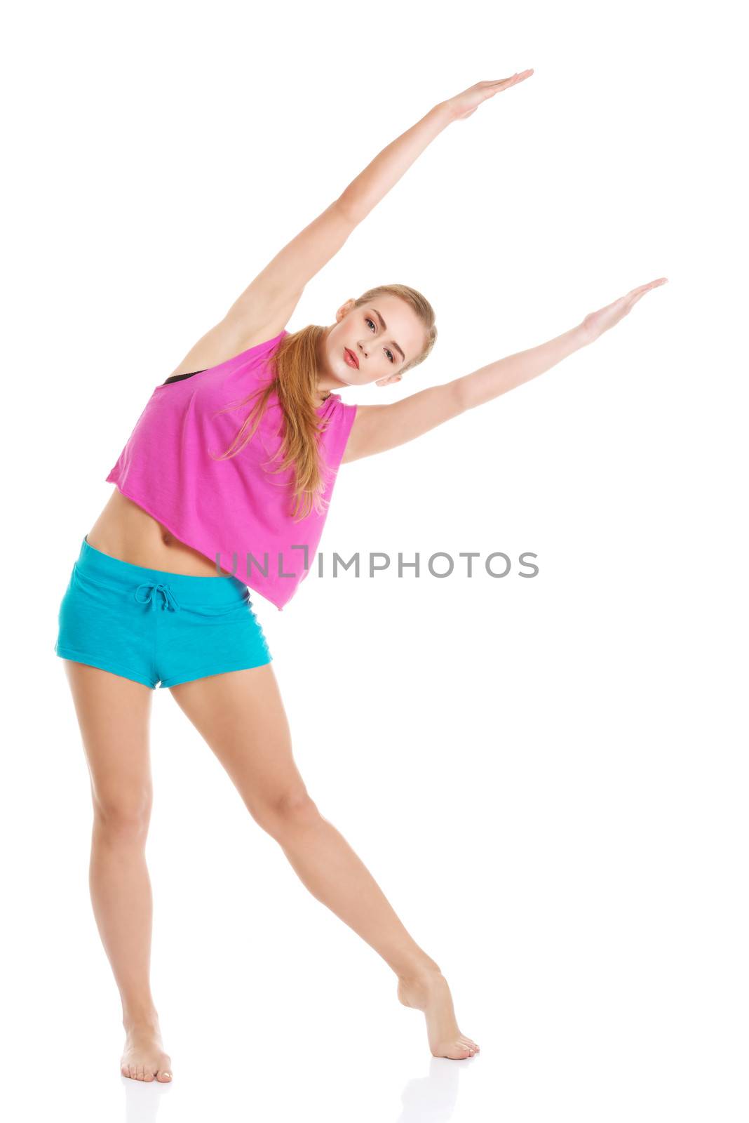 Beautiful caucasian woman is doing exercises. Isolated on white.