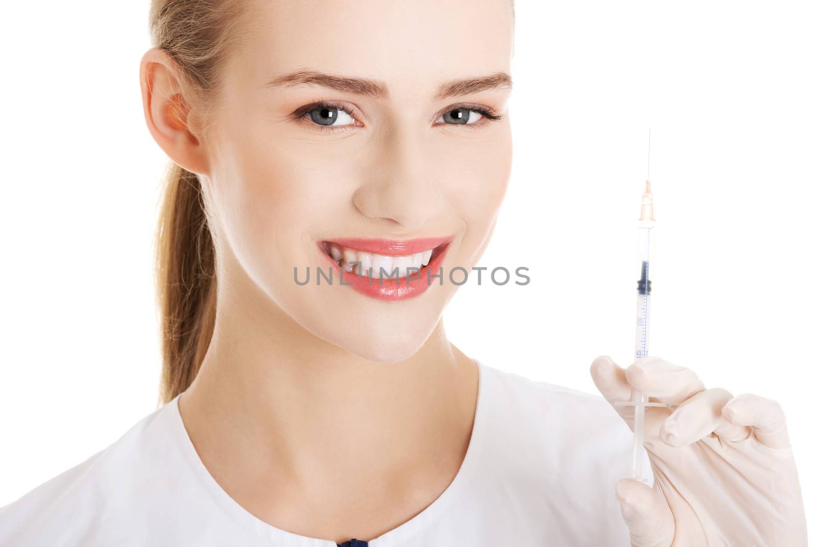 Beautiful young nurse with needle. Isolated on white.