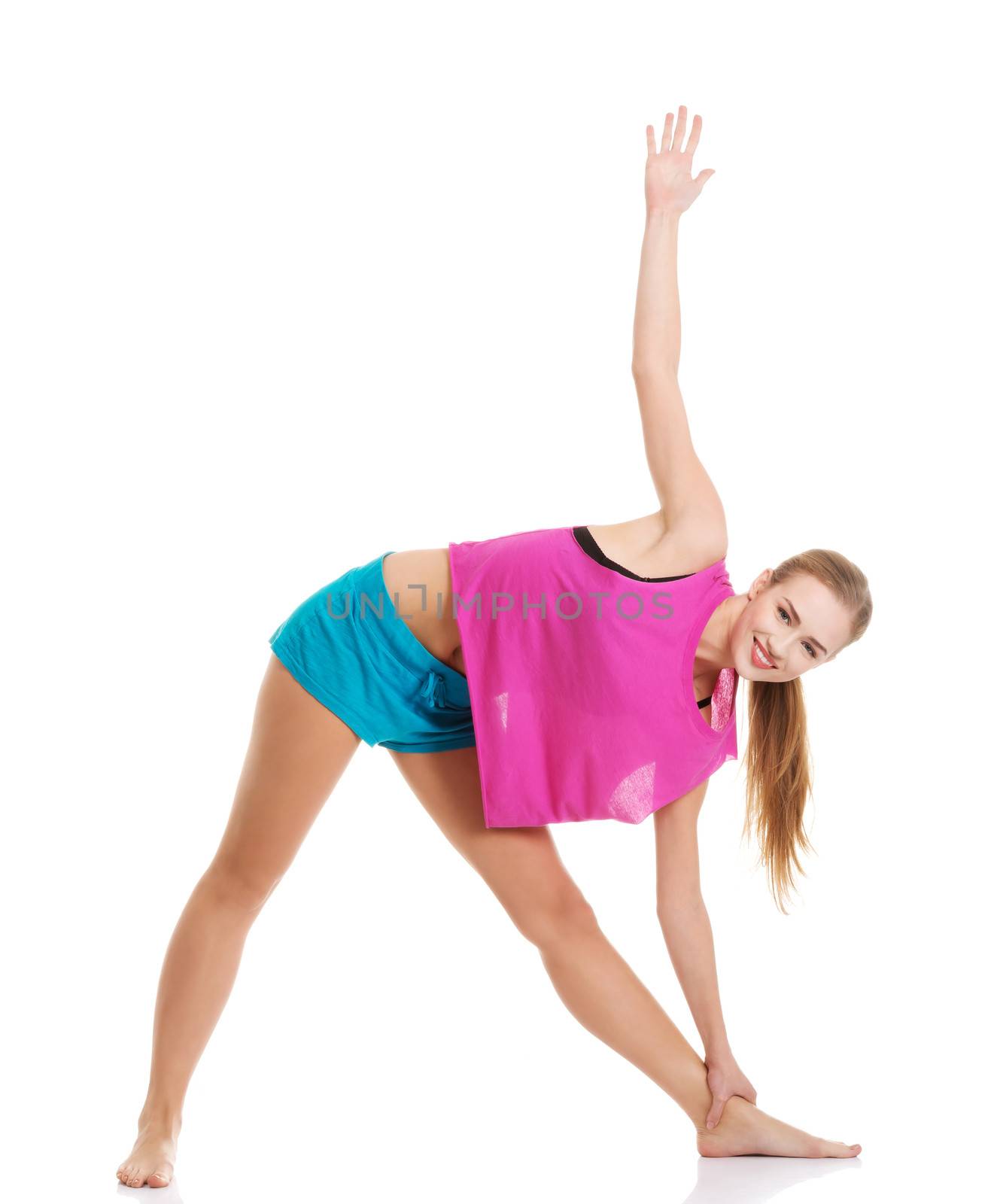 Young caucasian woman is exercising, stretching herself. Isolated on white.