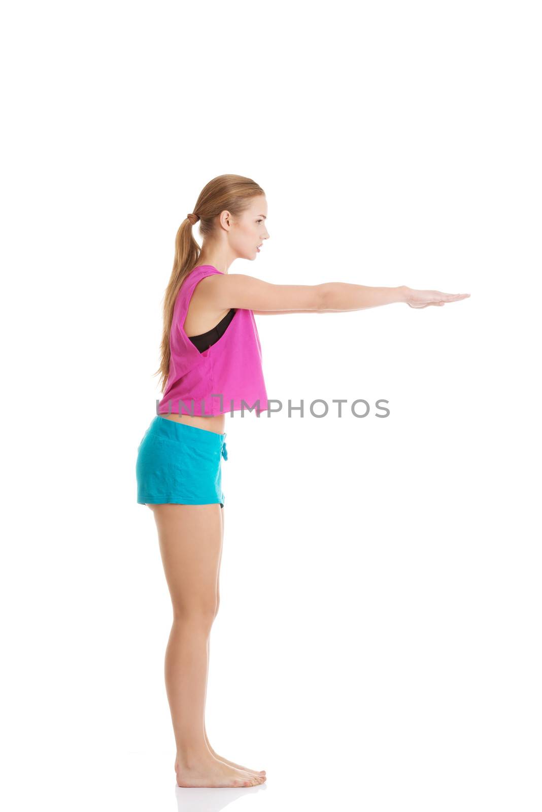 Young caucasian woman is doing exercises, wearing sportswear. Isolated on white.