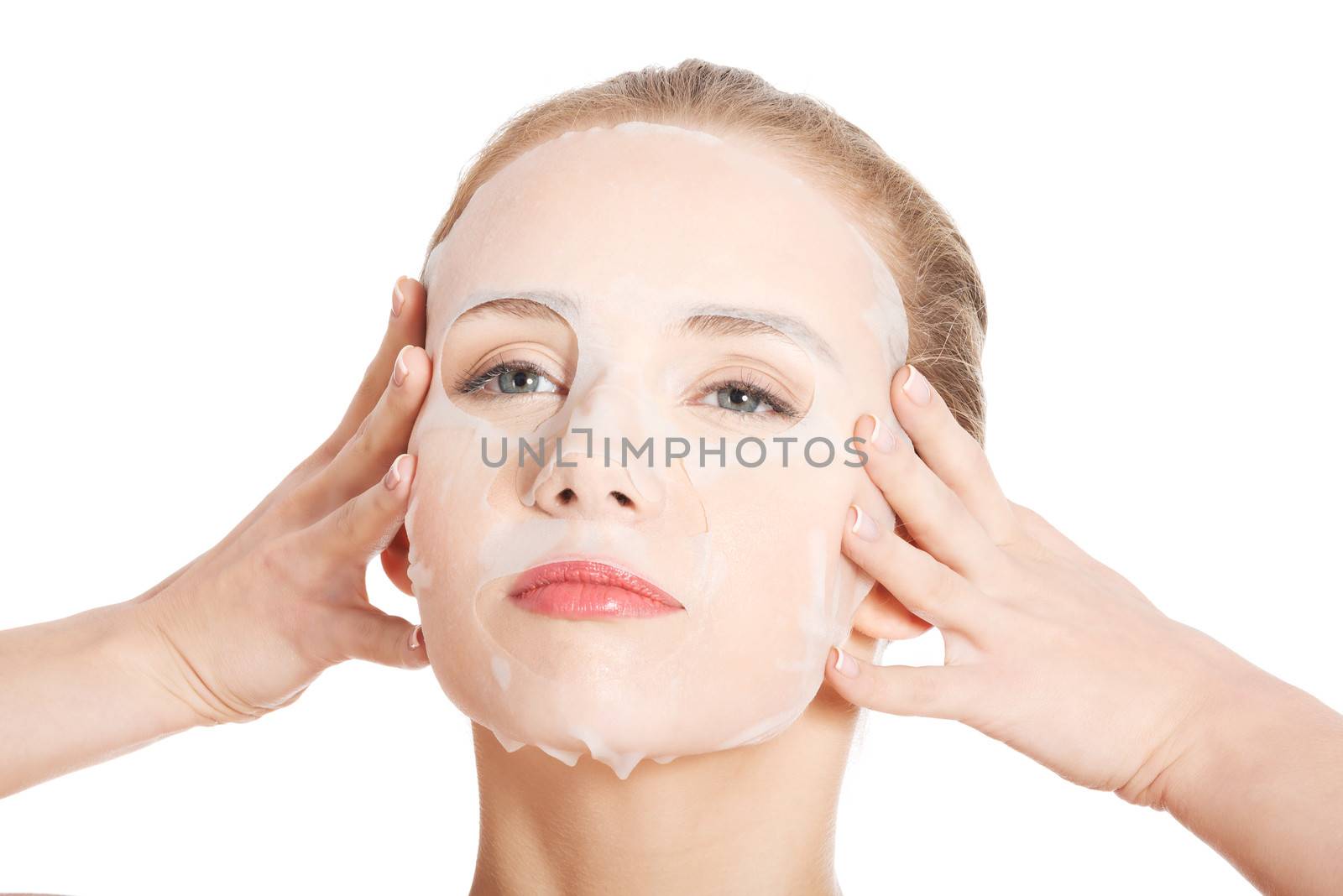 Beautiful young woman with collagen mask. Isolated on white.