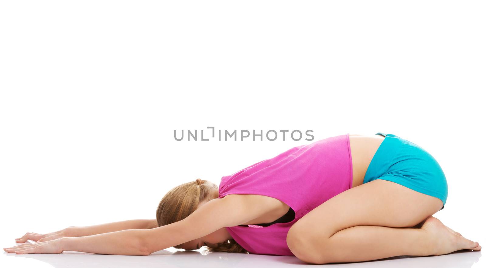 Young caucasian woman is exercising, stretching herself. Isolated on white.