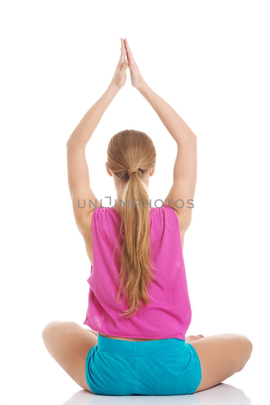 Beautiful young caucasian woman is exercising, doing yoga. Isolation on white.