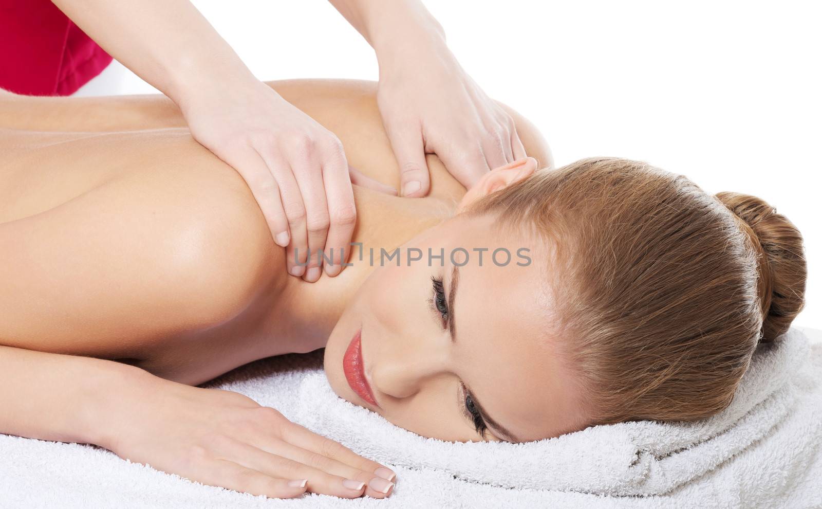 Beautiful caucasian woman lying on the massage table and is bein by BDS