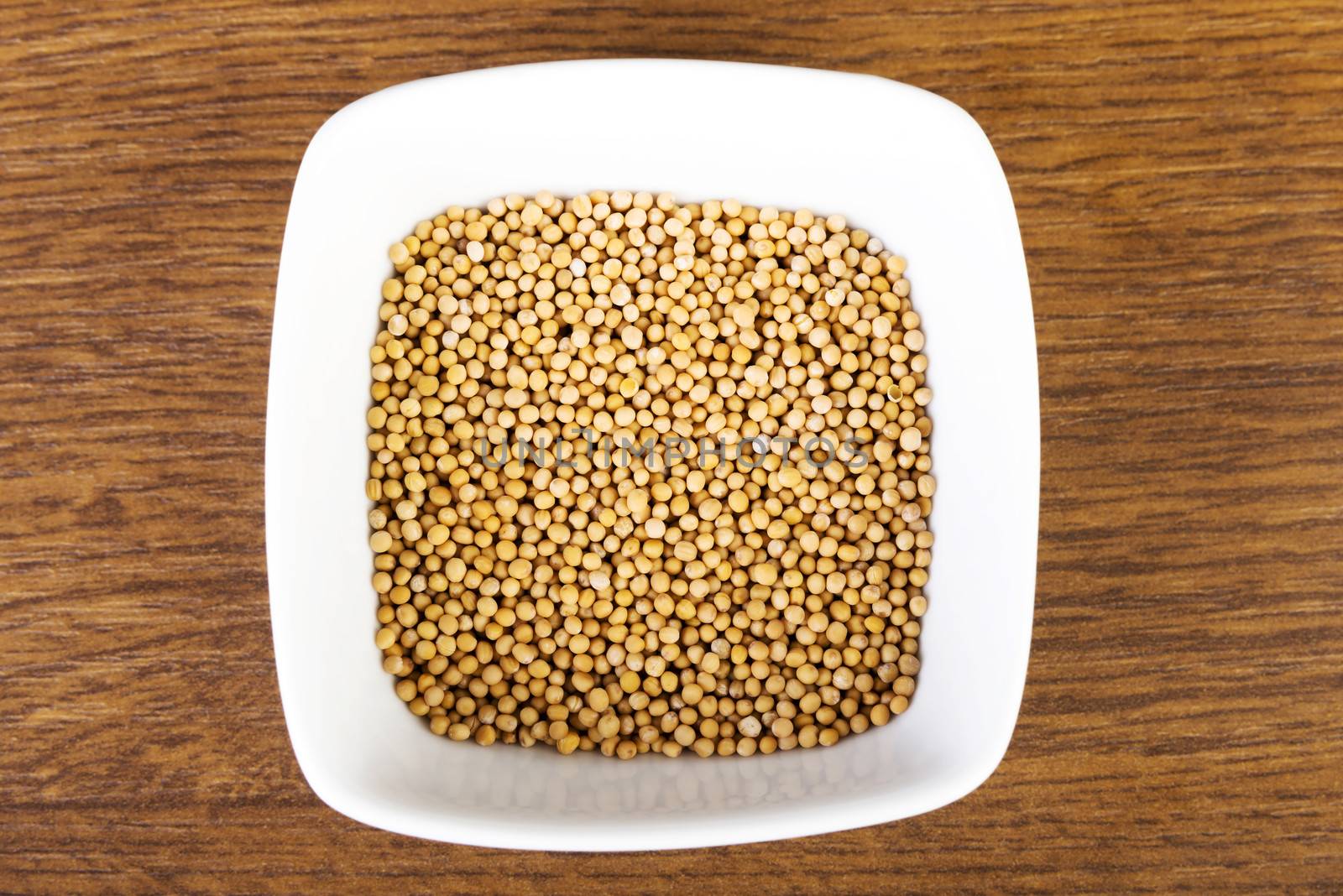 Peas or lentil in a bowl. Up front view. Standing over wooden table.