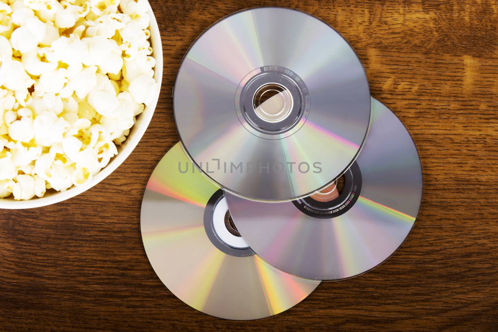 Picture of popcorn in a bowl and CDs. by BDS