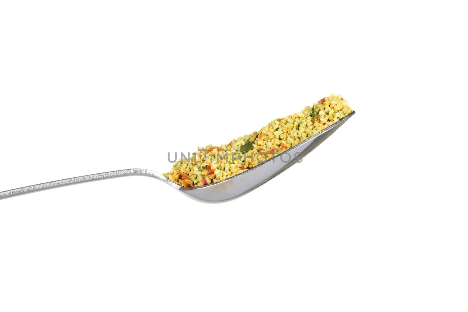 Close up on a spoon with spices. Isolated on white.