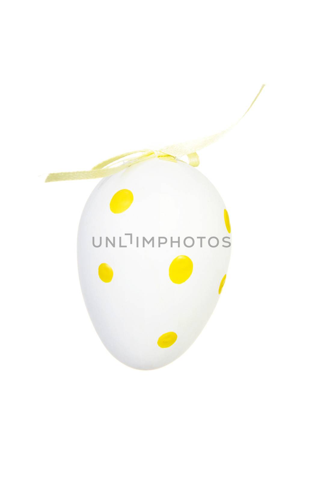 One separated white eggs in yellow dots decoration. Isolated on white.