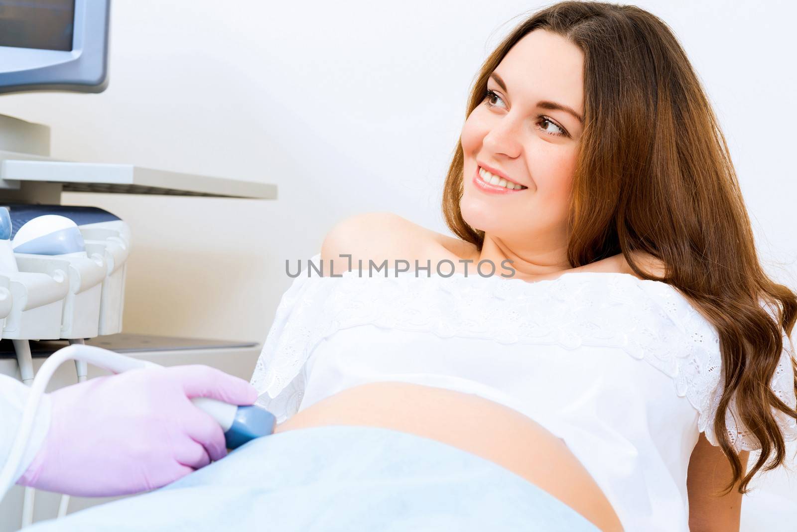 Young attractive pregnant woman on reception at the doctor, health check