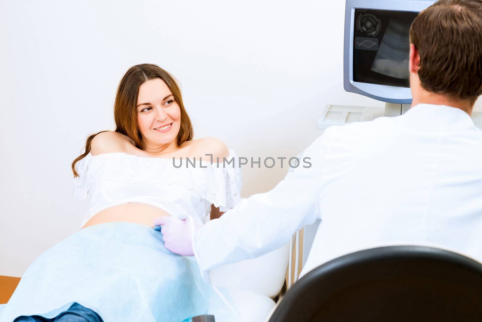 Young attractive pregnant woman on reception at the doctor, health check