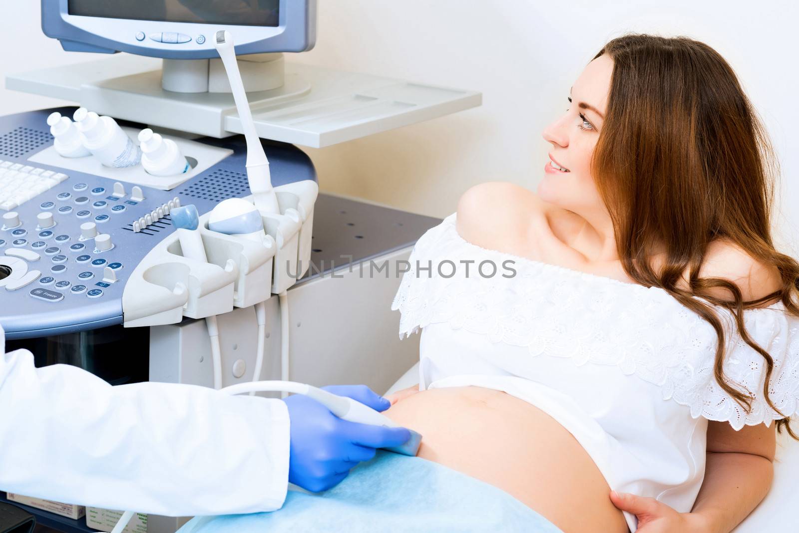 Young attractive pregnant woman on reception at the doctor, health check