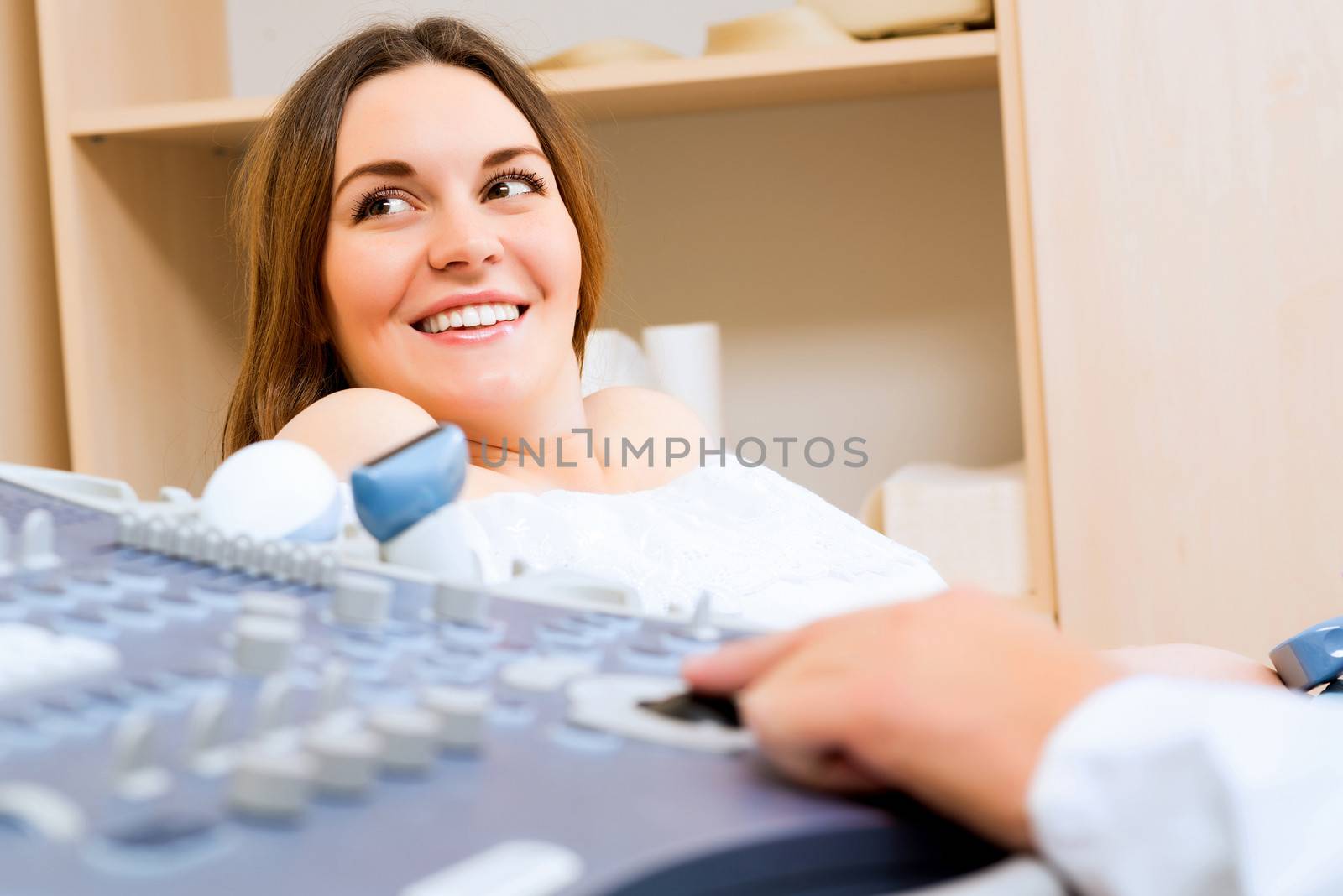 Young attractive pregnant woman on reception at the doctor, health check