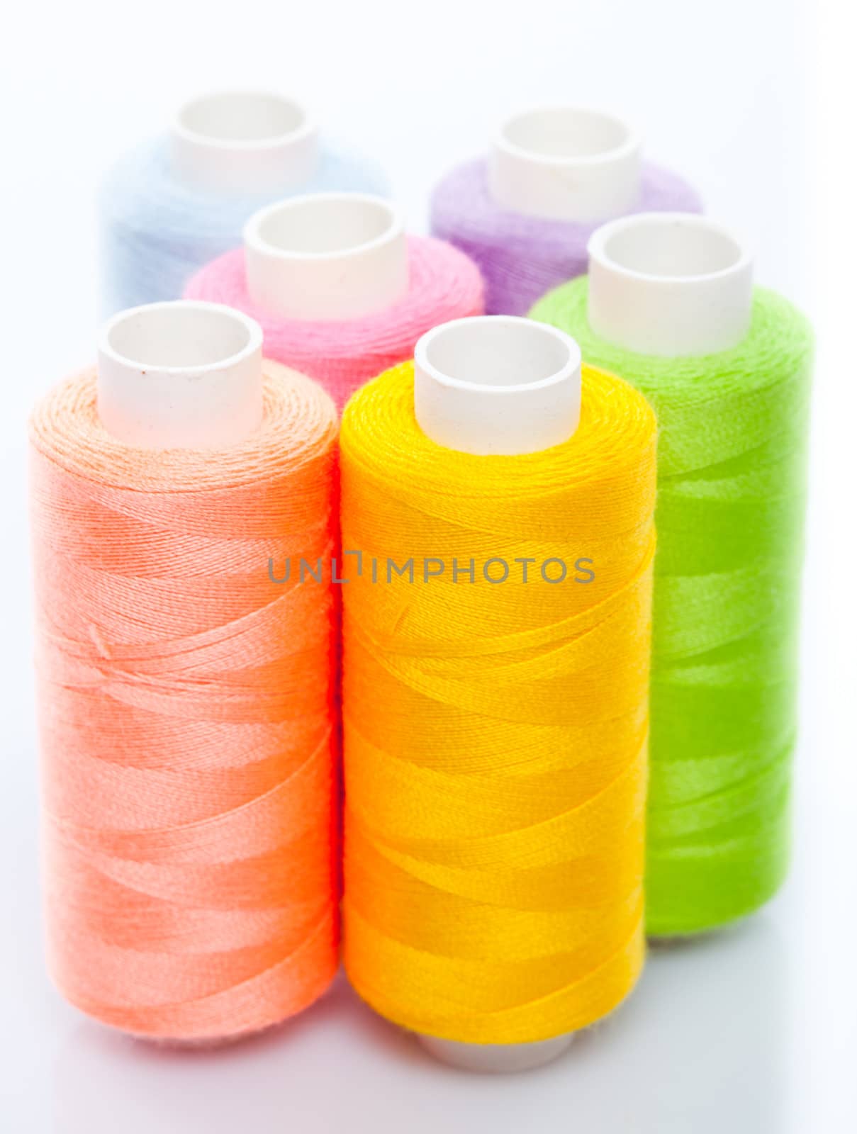 Sewing multicolored threads isolated on a white