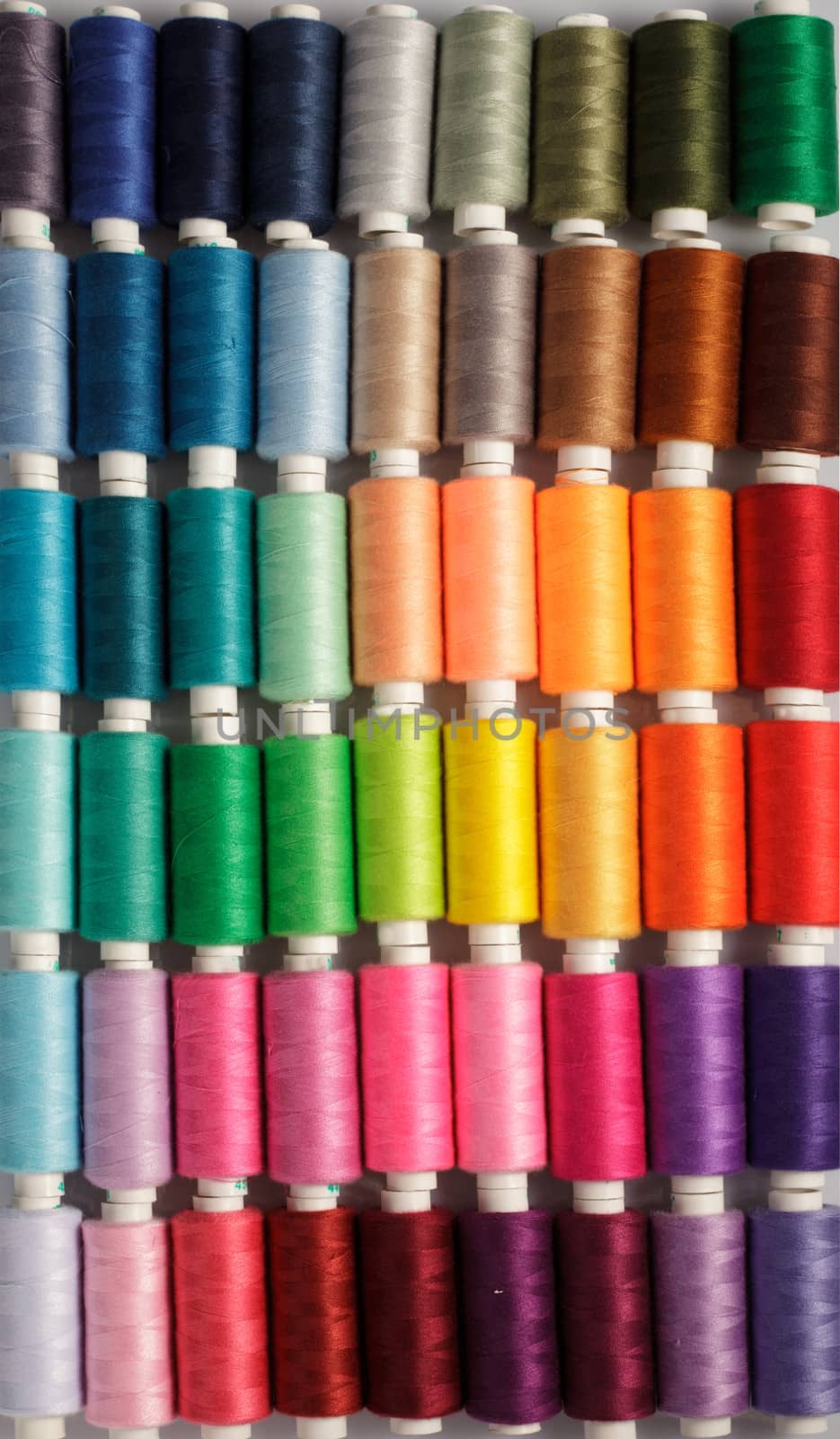 Sewing threads as a multicolored background close up