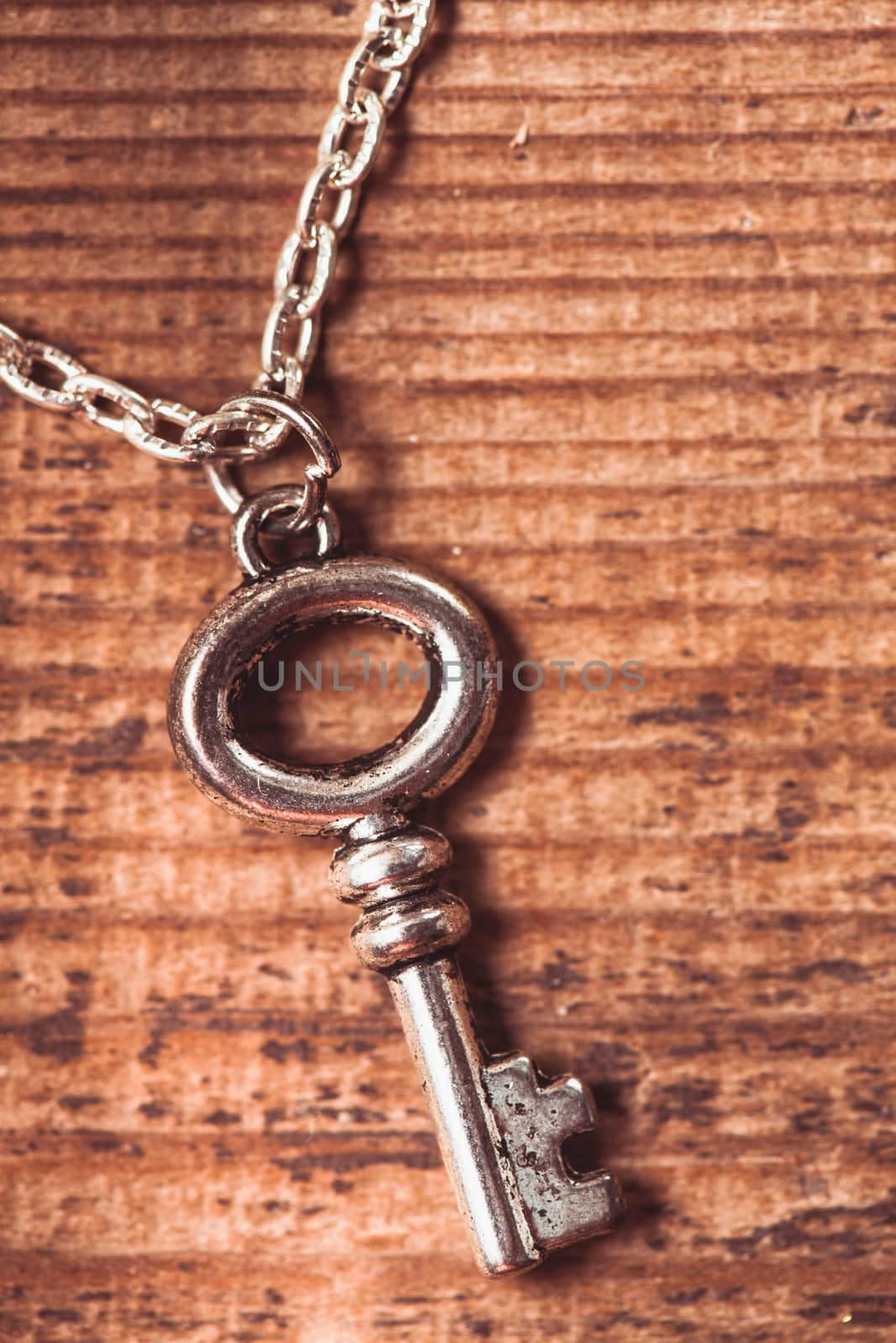 Vintage key on the wooden shabby background