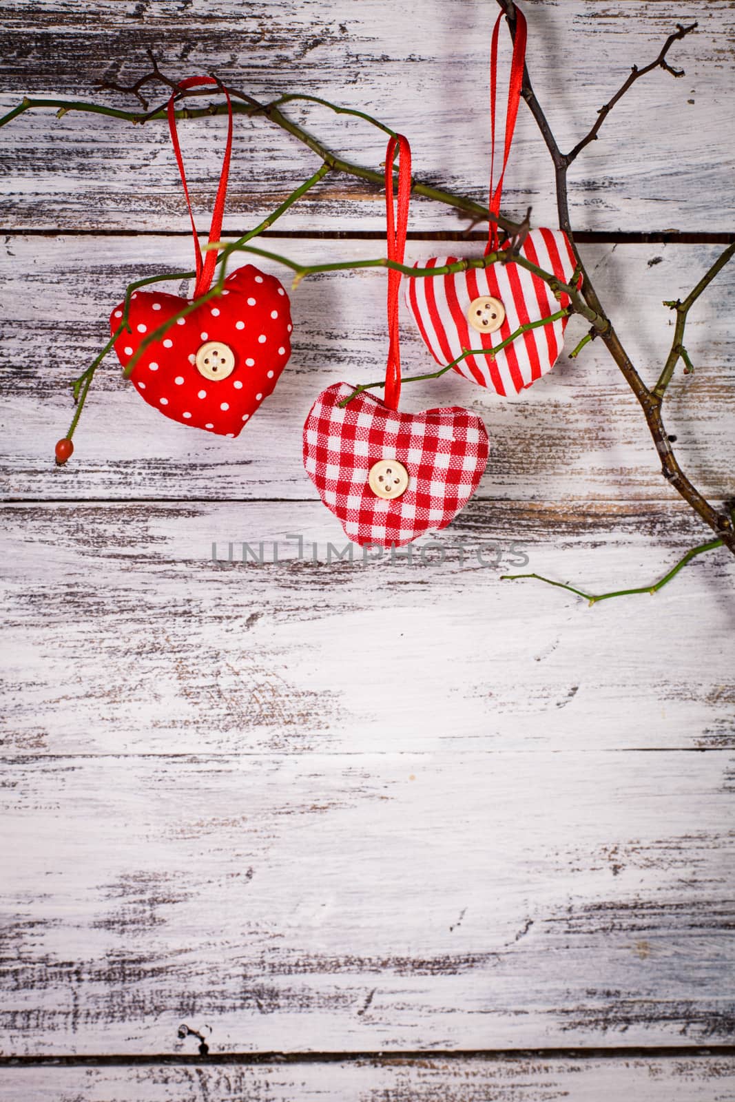 Valentine decorations: textile red hearts on the 
branch