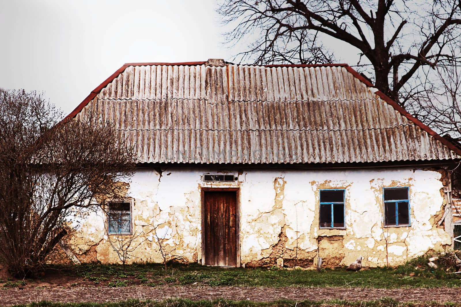 Abandoned old house on dramatic landscape