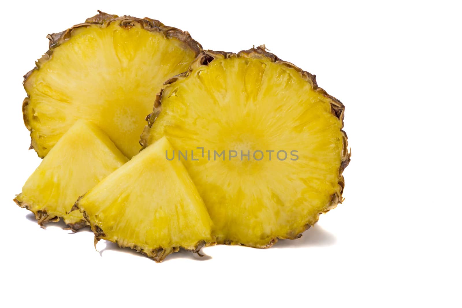 Two large slices of pineapple and two small slices. Presented on a white background.