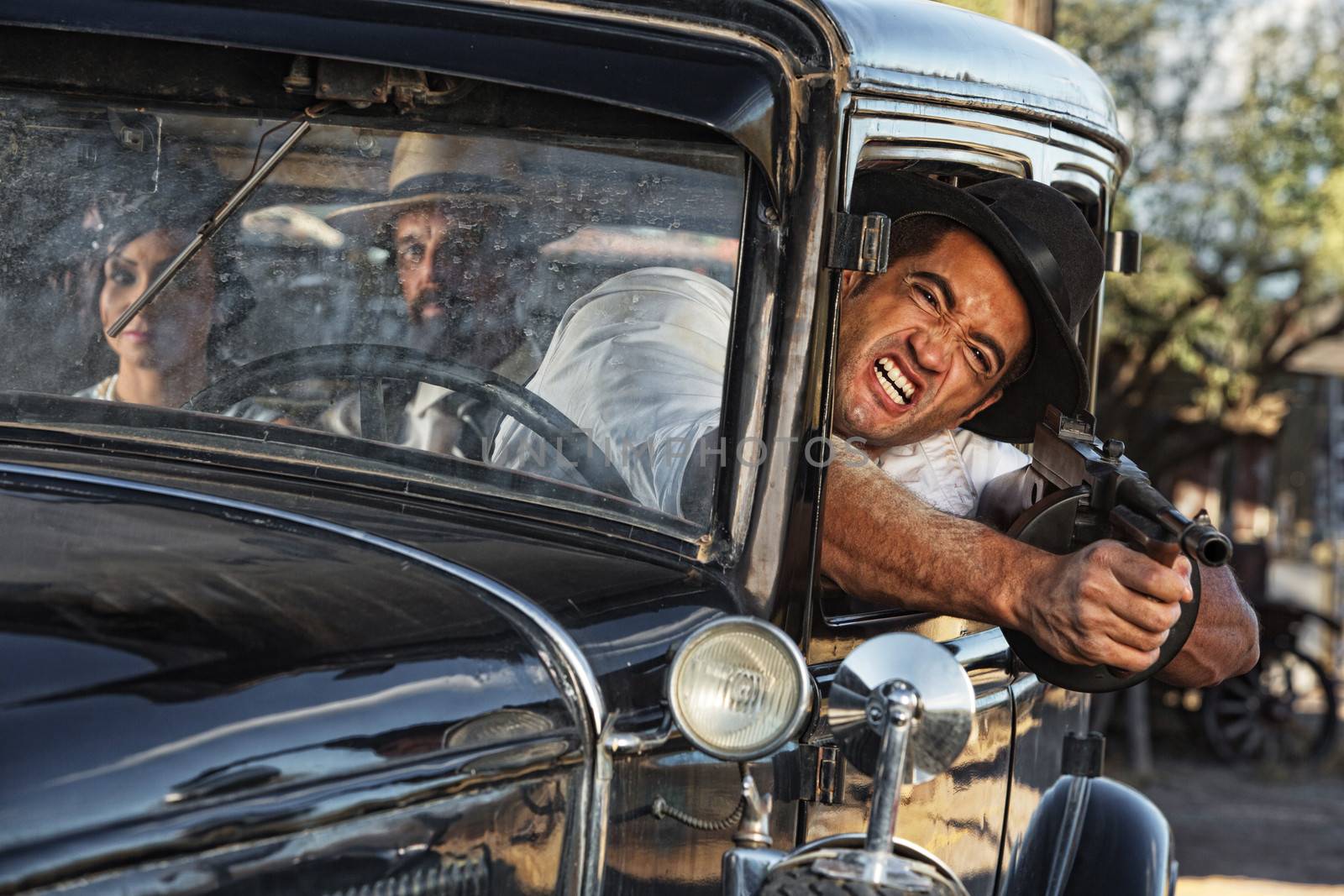 1920s gangster shooting gun from car window