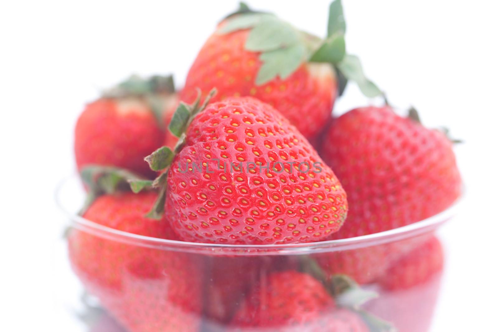 strawberry in a glass bowl isolated on white by jannyjus