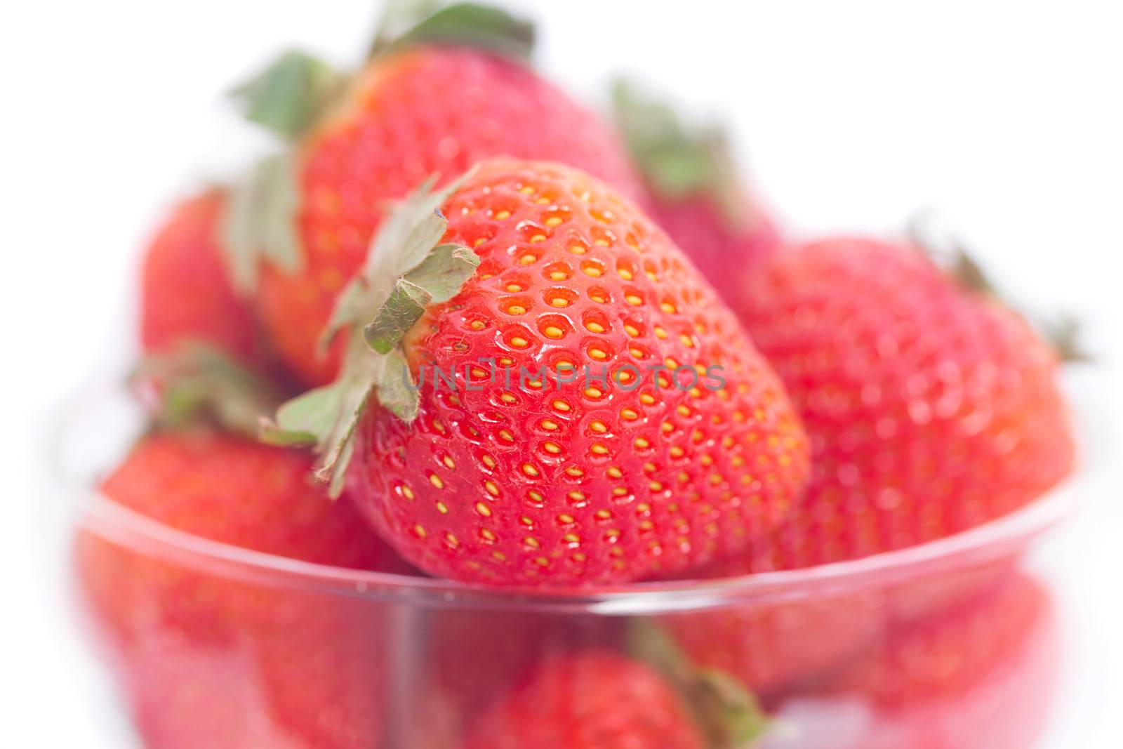 strawberry in a glass bowl isolated on white